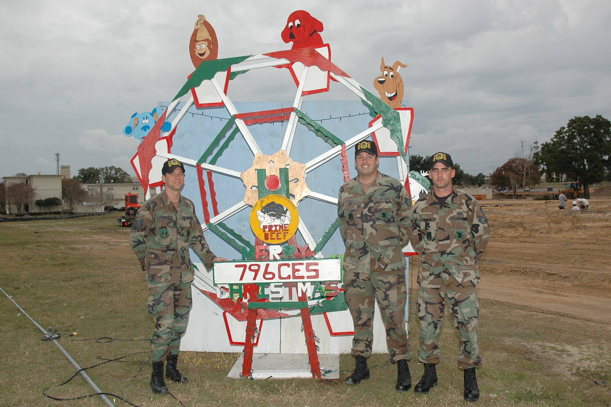 EGLIN AIR FORCE BASE, Fla. -- Tech. Sgt. David Ulbrick (left), Staff Sgts. Jody Lucas, Jerry Fruth and Joshua Hallmark (not pictured), 796th Civil Engineer Squadron Airmen, designed and built this holiday ferris wheel, earning first place in the 2007 Team Eglin Organization Holiday Greeting Card Competition. Members from the 96th Ground Combat Training Squadron earned second place, third place went to the 1st Special Operations Maintenance Squadron and the 96th Communications Squadron earned an Honorable Mention. The entries were judged by representatives from JOBSPLUS Veterans Services, the American Red Cross and the Airman & Family Readiness Center. (U.S. Air Force photo by Staff Sgt. LuCelia Ball)