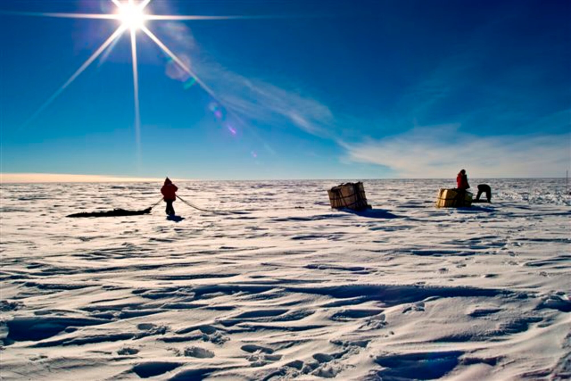 Containerized Delivery System bundles are recovered by a ground crew member at the South Pole. The bundles were airdropped by a McChord C-17 supporting Operation Deep Freeze.  The 13th Air Force-led Operation Deep Freeze is a unique joint and total force mission that has supported the National Science Foundation and U.S. Antarctic Program since 1955.  By validating the C-17 capability to complete airdrop missions at the Geographical South Pole, Joint Task Force-Support Forces Antarctica demonstrated its ability to provide mid-winter emergency re-supply and flexible support to the National Science Foundation and U.S. Antarctica Program. (U.S. Air Force photo)