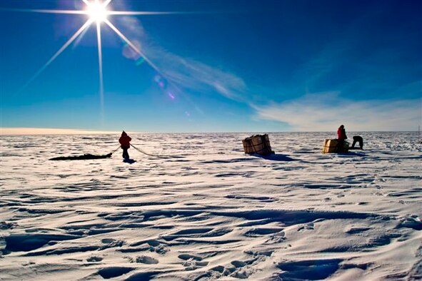 Containerized Delivery System bundles are recovered by a ground crew member at the South Pole. The bundles were airdropped by a McChord C-17 supporting Operation Deep Freeze. The 13th Air Force-led Operation Deep Freeze is a unique joint and total force mission that has supported the National Science Foundation and U.S. Antarctic Program since 1955. By validating the C-17 capability to complete airdrop missions at the Geographical South Pole, Joint Task Force-Support Forces Antarctica demonstrated its ability to provide mid-winter emergency re-supply and flexible support to the National Science Foundation and U.S. Antarctica Program. (Courtesy photo by Forest Banks, IceCube Project) 
