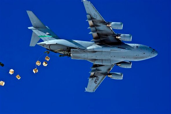 A McChord Air Force Base C-17 airdrops Containerized Delivery System bundles to the South Pole. The C-17 is part of 13th Air Force-led Operation Deep Freeze, a unique joint and total force mission that has supported the National Science Foundation and U.S. Antarctic Program since 1955. By validating the C-17 capability to complete airdrop missions at the Geographical South Pole, Joint Task Force-Support Forces Antarctica demonstrated its ability to provide mid-winter emergency re-supply and flexible support to the National Science Foundation and U.S. Antarctica Program. (Courtesy photo by Forest Grant, IceCube Project) 