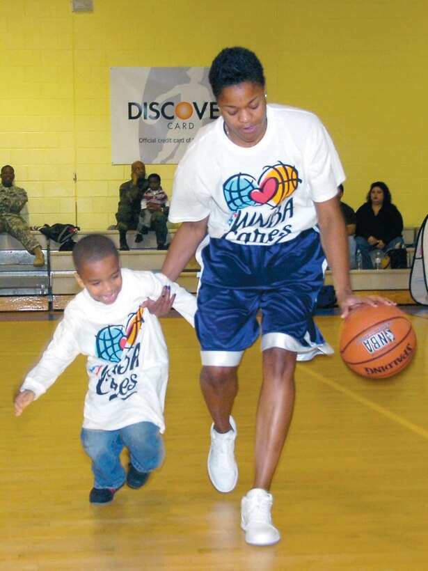 Cameron Lightfoot, 5, gets a lesson in basic drivvling from Alana Beard on Dec. 14. Cameron is the grandson of Chief Warrant Officer (ret.) Charles Lightfoot. (US Air Force/Bobby Jones)