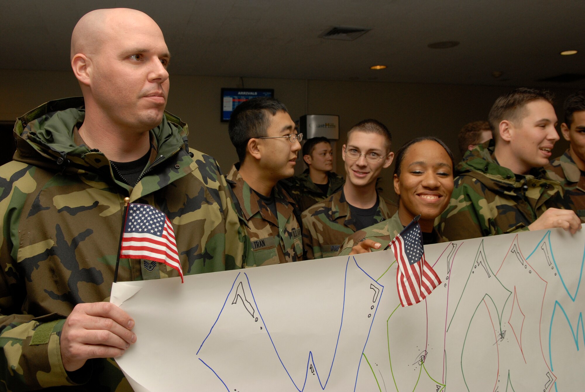 VANDENBERG AIR FORCE BASE, Calif. -- Airman 1st Class Michael Brady is greeted by fellow Airmen upon his return home Dec. 18.  Airman Brady, who deployed to Iraq, was performing Combat Camera support for soldiers when he was wounded in the neck by enemy fire near Ad Diwaniyah, Iraq, Oct. 12.  Airman Brady was awarded the Purple Heart and the Iraqi Campaign Medal from Brig. Gen. Burt Field, the 332nd Air Expeditionary Wing commander, while still in Iraq.  Airman Brady was accompanied by his family and was met by a large group of friends and coworkers. (U.S. Air Force photo/Airman 1st Class Christian Thomas)

