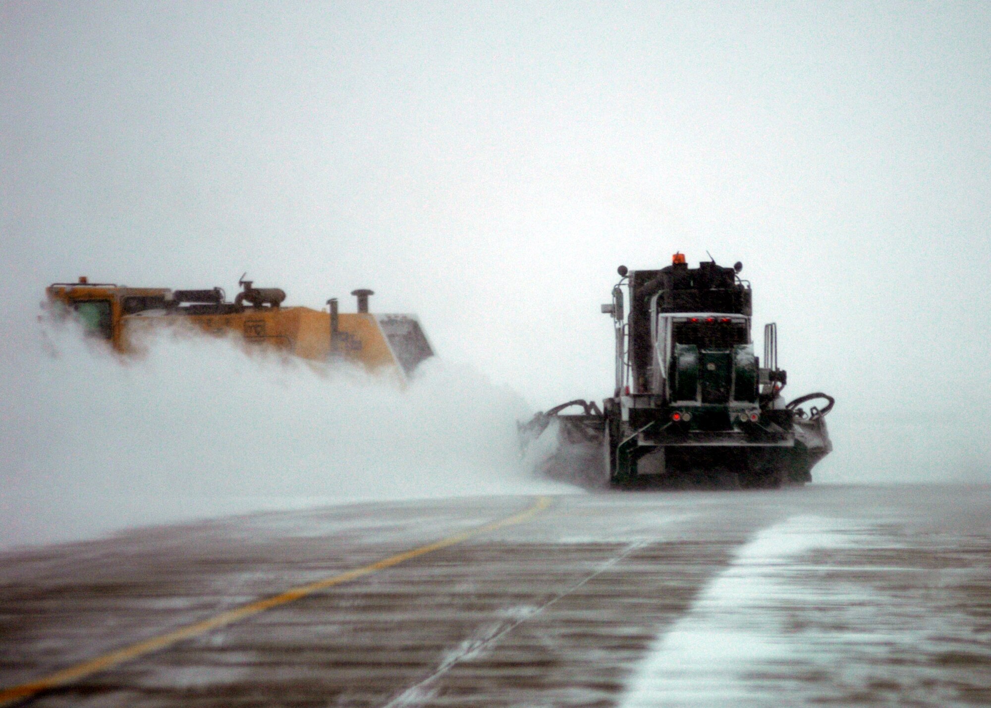 GRAND FORKS AIR FORCE BASE, N.D. ? Heavy equipment operators, affectionately referred to as ?Dirt Boyz? by their fellow civil engineer squadron peers, clear the flightline here Dec. 4 after a snow storm using sweepers, plows and graters (photo/Staff Sgt. J. Paul Croxon).