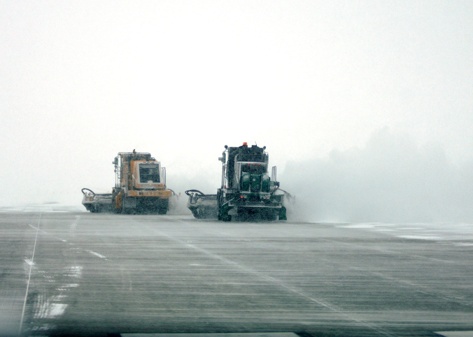 GRAND FORKS AIR FORCE BASE, N.D. ? Heavy equipment operators, affectionately referred to as ?Dirt Boyz? by their fellow civil engineer squadron peers, clear the flightline here Dec. 4 after a snow storm using sweepers, plows and graters (photo/Staff Sgt. J. Paul Croxon).