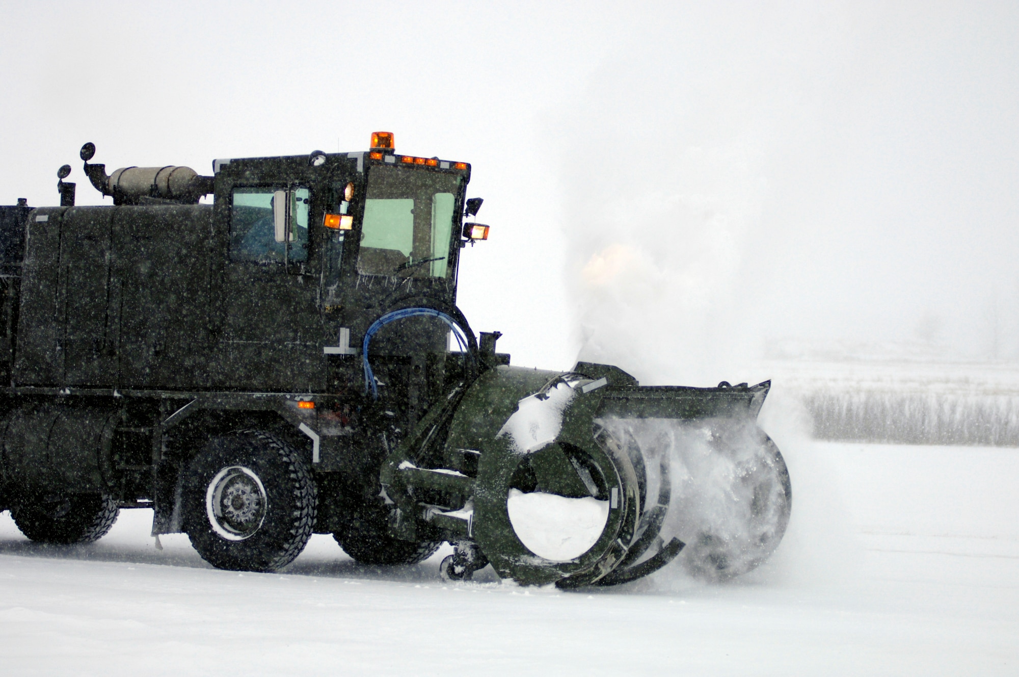 GRAND FORKS AIR FORCE BASE, N.D. ? Heavy equipment operators, affectionately referred to as ?Dirt Boyz? by their fellow civil engineer squadron peers, clear the flightline here Dec. 4 after a snow storm using sweepers, plows and graters (photo/Staff Sgt. J. Paul Croxon).