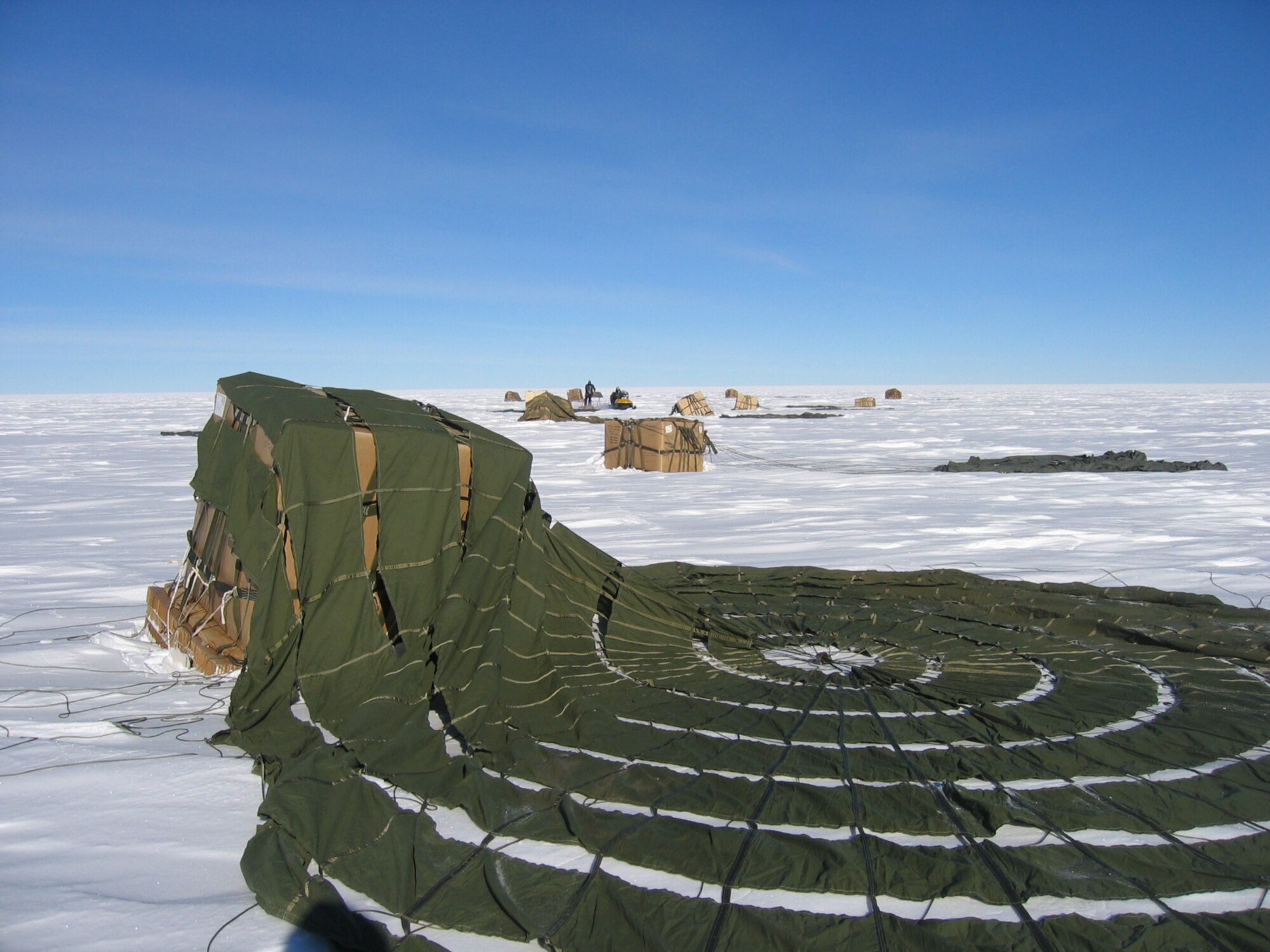 Supplies airdropped by a McChord C-17 on the drop zone at the South Pole. By validating the C-17 capability to complete airdrop missions at the Geographical South Pole, JTF-SFA demonstrated its ability to provide mid-winter emergency re-supply and flexible support to the National Science Foundation and U.S. Antarctica Program.  (U.S. Air Force photo)