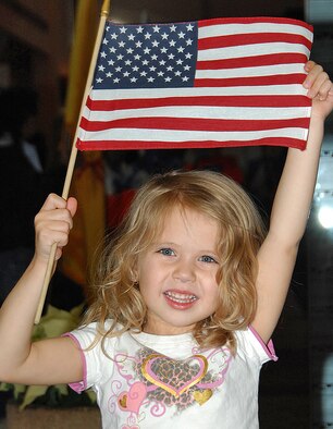 Zoe Wright, 4, waves her flag welcoming home the  Airmen returning to Kirtland AFB on Dec. 9. U.S. Air Force photo by Todd Berenger