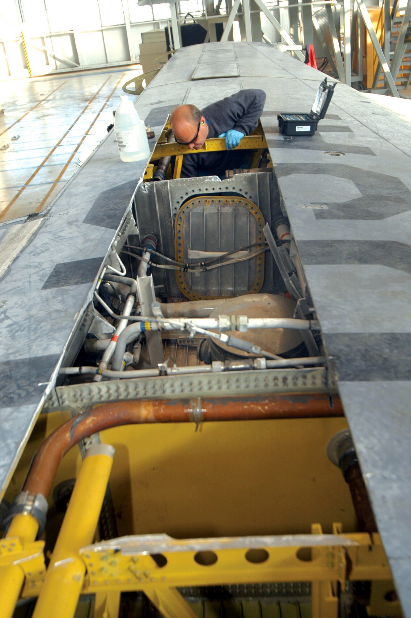 Michael Gayon does a seal repair inside of a fuel tank on the C-130 Hercules wing at Robins Air Force Base, Ga. Robins AFB units combined forces to procure a wing so students of the 373rd Training Squadron's Field Training Detachment could have hands-on training. (U.S. Air Force photo/Sue Sapp) 
