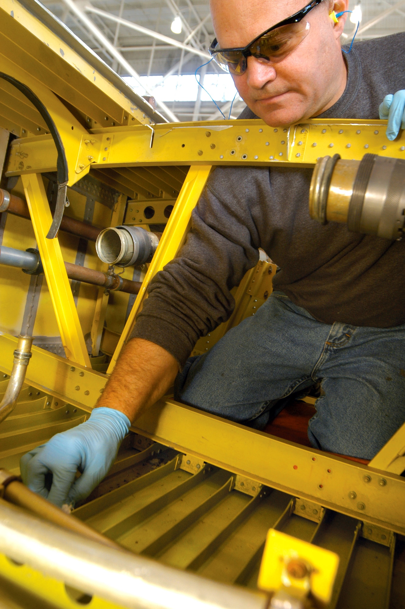 Michael Gayon does a seal repair inside of a fuel tank on the C-130 Hercules wing at Robins Air Force Base, Ga. Robins AFB units combined forces to procure a wing so students of the 373rd Training Squadron's Field Training Detachment could have hands-on training. (U.S. Air Force photo/Sue Sapp) 
