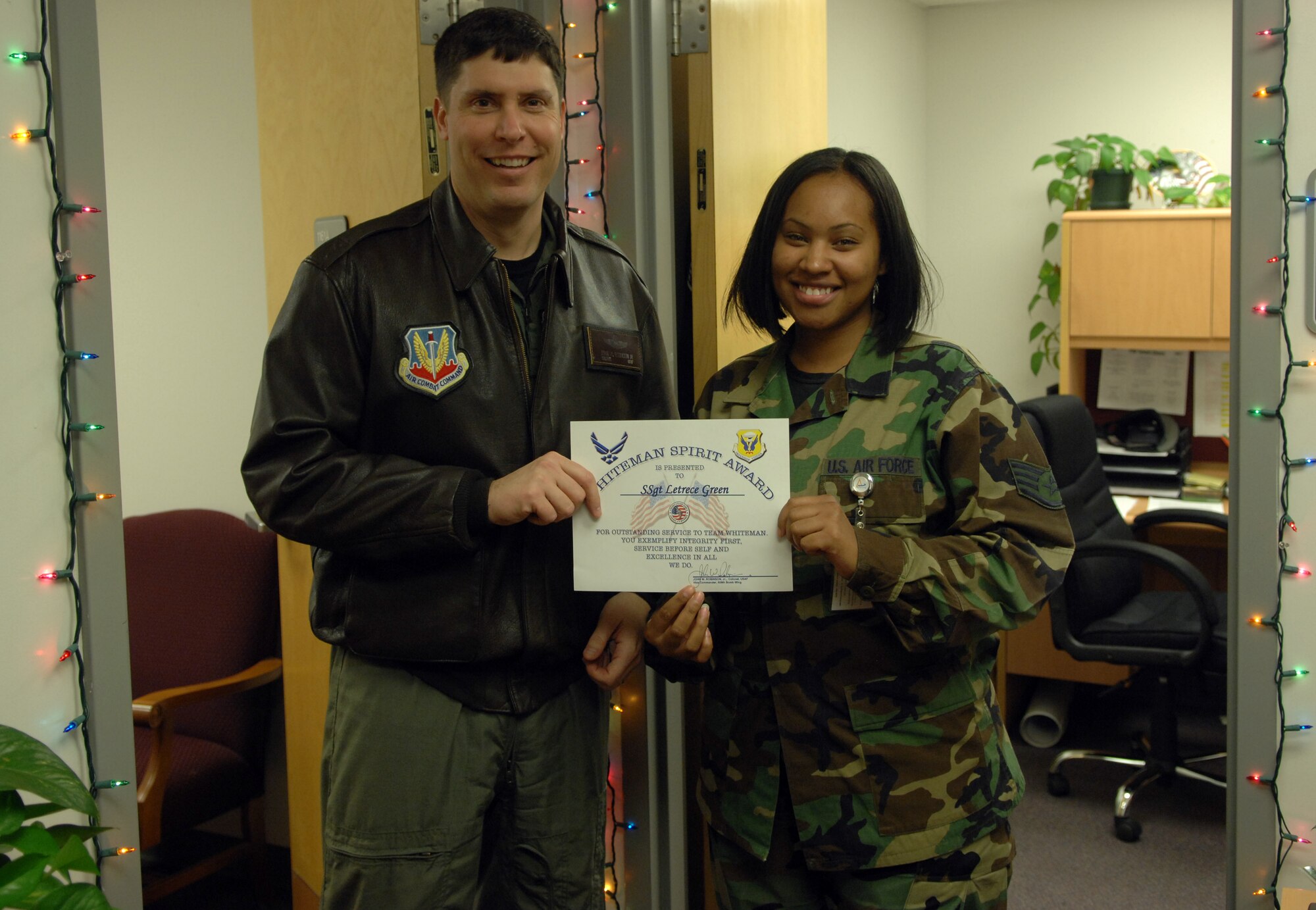 Whiteman Air Force Base, Mo. - Col. John Robinson, 509th Bomb Wing vice commander, presents the Whiteman Spirit Award to Staff Sgt. Letrece Green, 509th Medical Support Squadron, Dec. 18. (U.S. Air Force photo/A1C Cory Todd)
