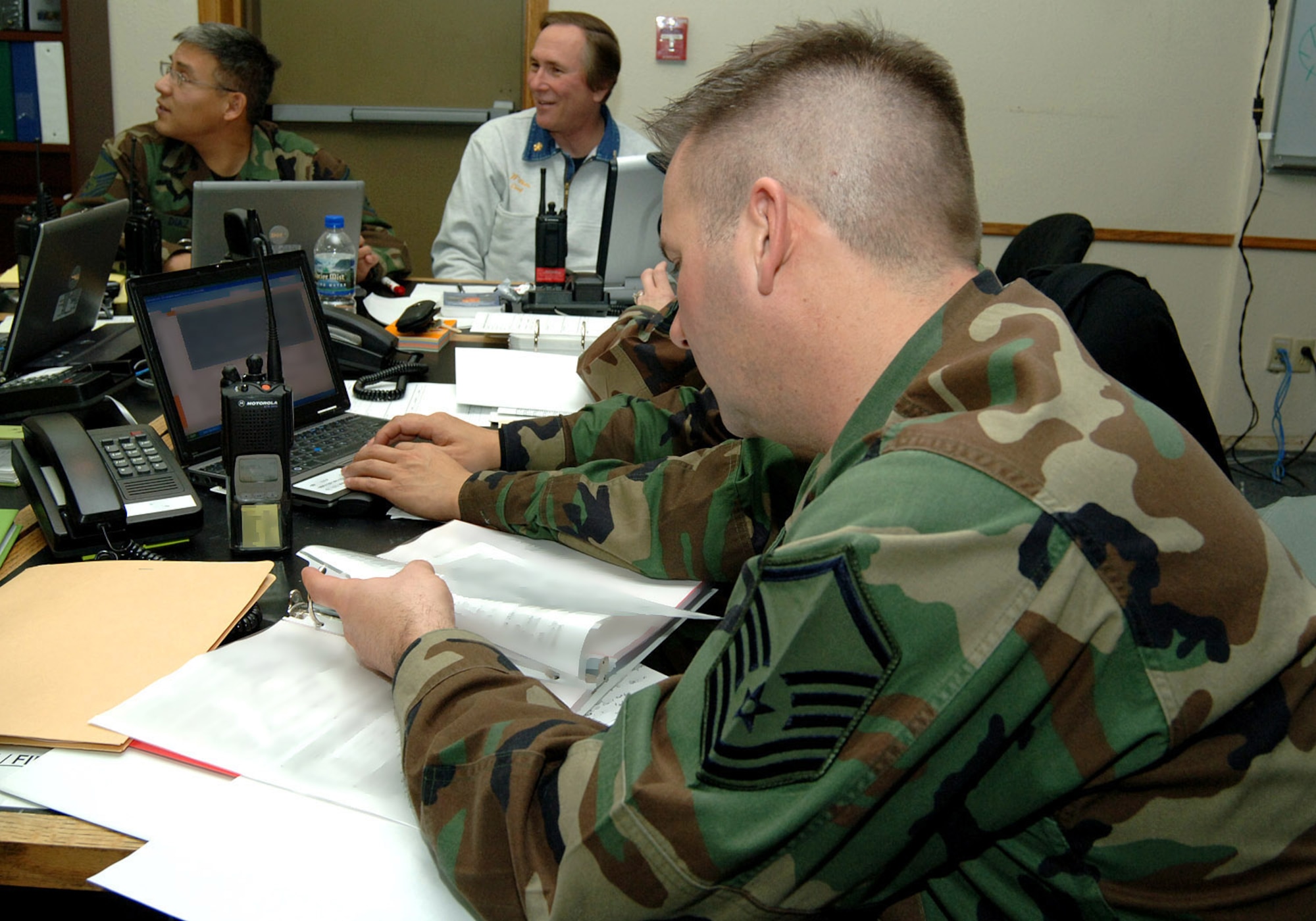 Master Sgt. Sean Reiling, 319th Aeromedical Dental Squadron, reviews documents in the emergency operations center during the Mass Accident Response Exercise here on December 18, 2007. This MARE was designed to ensure Airmen in the 319th Air Refueling Wing, to include high ranking officials and commanders, are prepared to respond to a base-wide emergency quickly and effectively (photo/Senior Airman SerMae Lampkin) 
