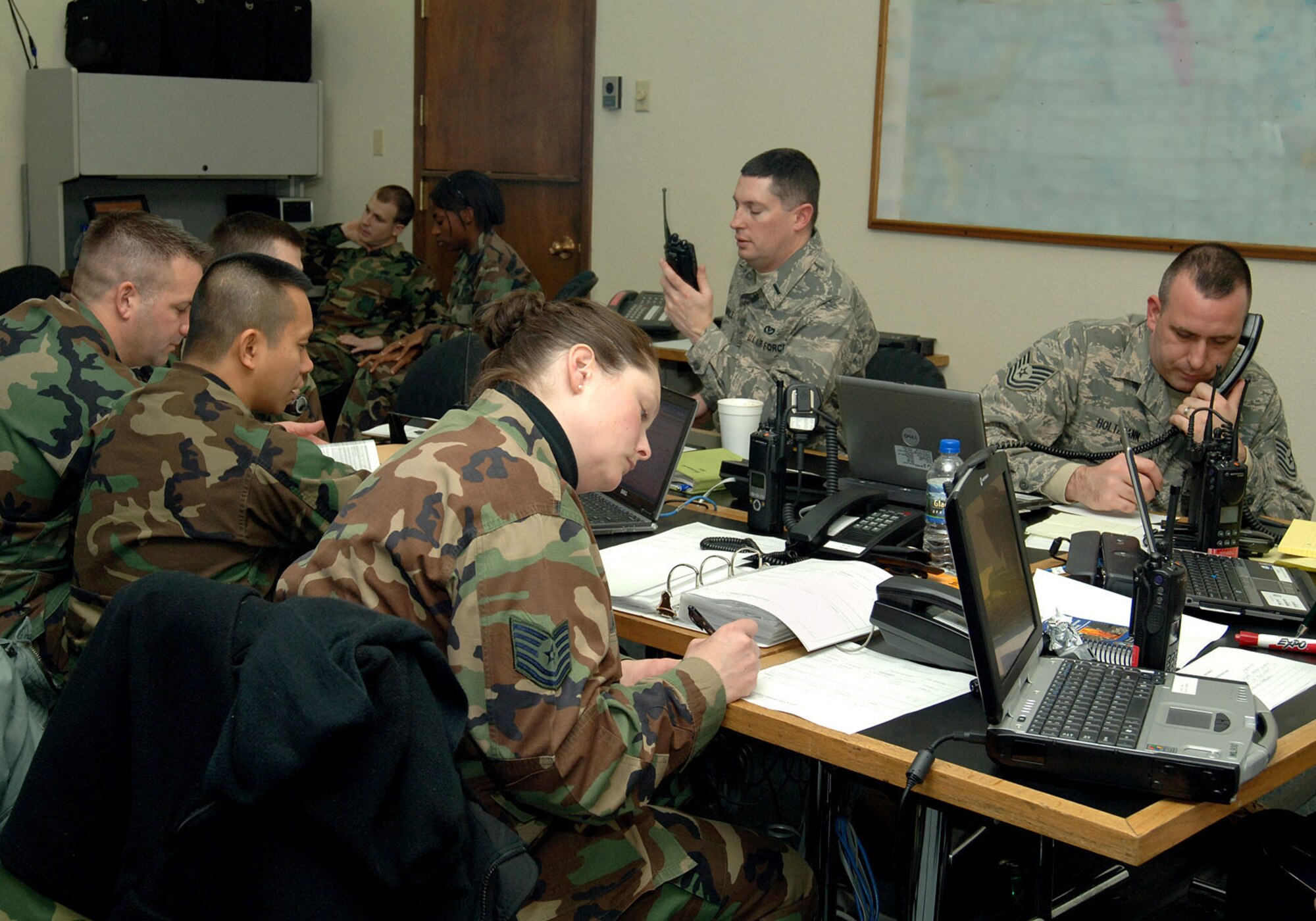Emergency response team members communicate critical information with first responders and the commander?s senior staff during a table-top major accident response exercise at the emergency operations center here on December 18, 2007. This MARE was designed to ensure Airmen in the 319th Air Refueling Wing, to include high ranking officials and commanders, are prepared to respond to a base-wide emergency quickly and effectively (photo/Senior Airman SerMae Lampkin) 
