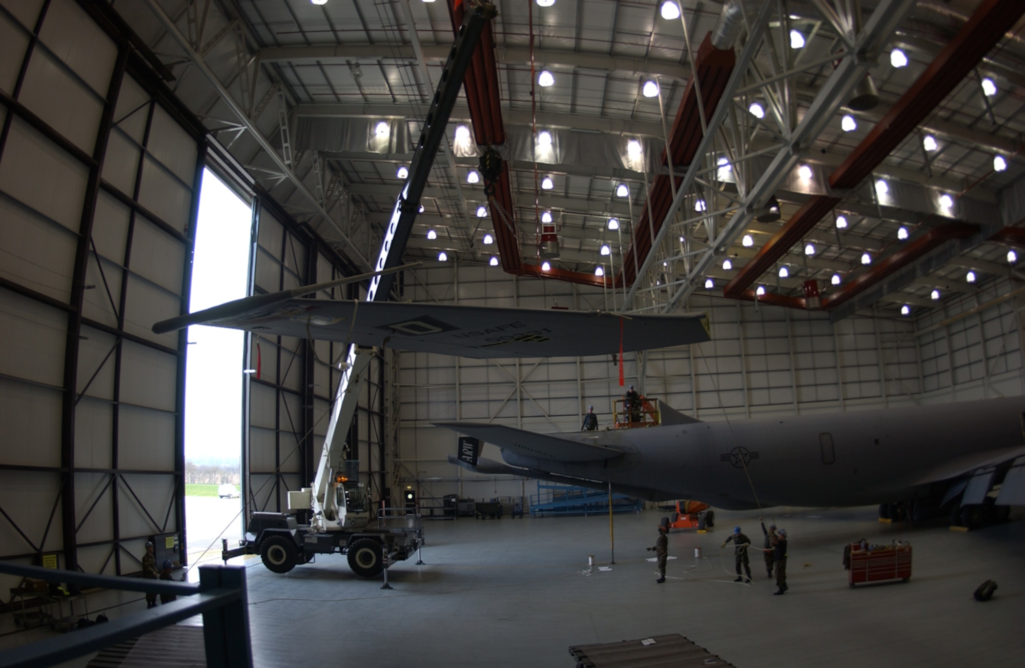 About a dozen Airmen with the 100th Maintenance Group helped remove and replace a vertical stabilizer on a KC-135 Stratotanker here Dec. 16. (U.S. Air Force photo by Senior Airman Clark Staehle)                            
