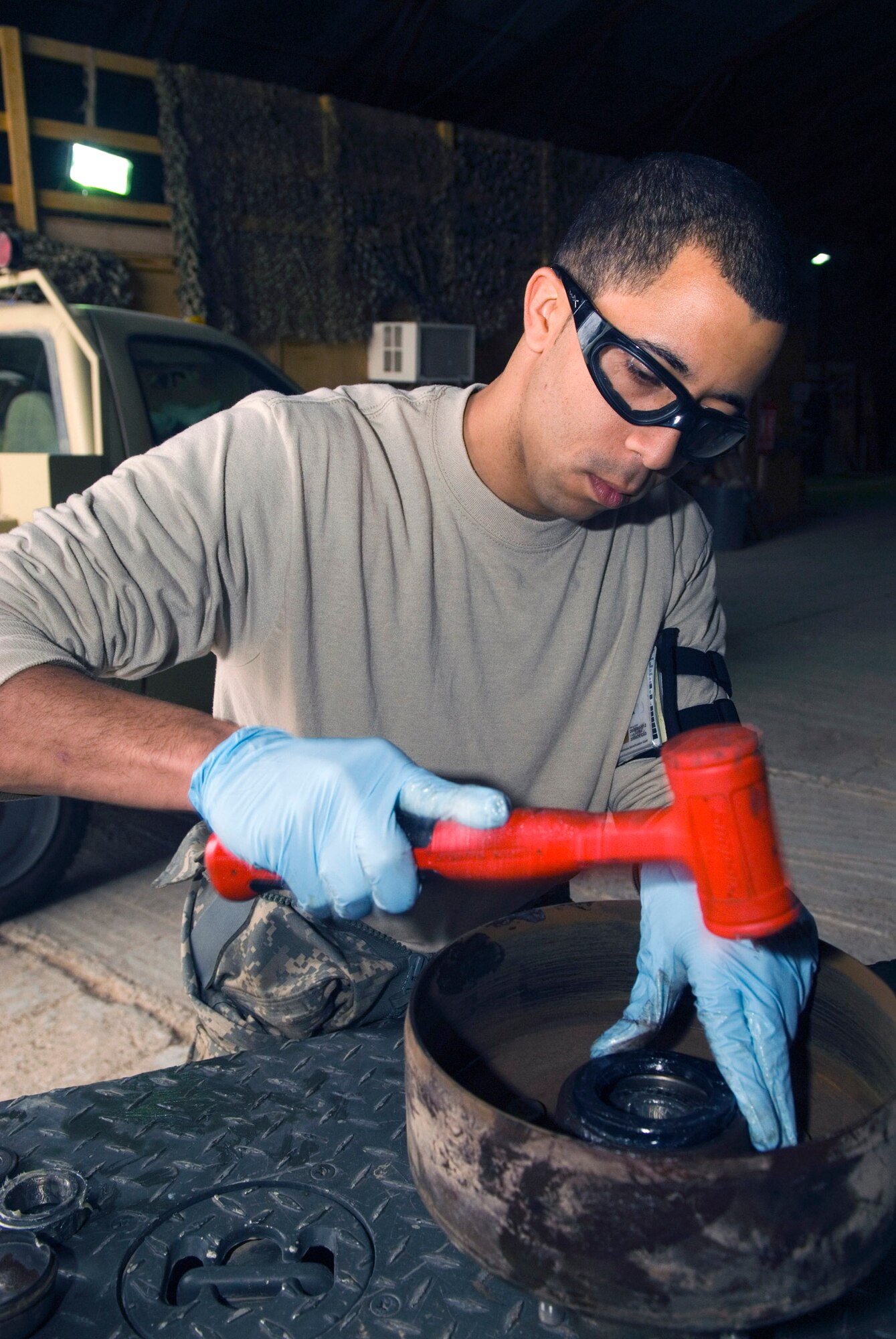 Staff Sgt. Elvin Rose secures a bearing seal onto the brake drum of a munitions trailer Dec. 19 at Balad Air Base, Iraq. The trailer is being disassembled as part of a 720-day inspection to see if there are any problems that could make it inoperable. Sergeant Rose is a 332nd Expeditionary Maintenance Squadron munitions equipment maintainer and is deployed from Spangdahlem Air Base, Germany. (U.S. Air Force photo/Staff Sgt. Joshua Garcia)