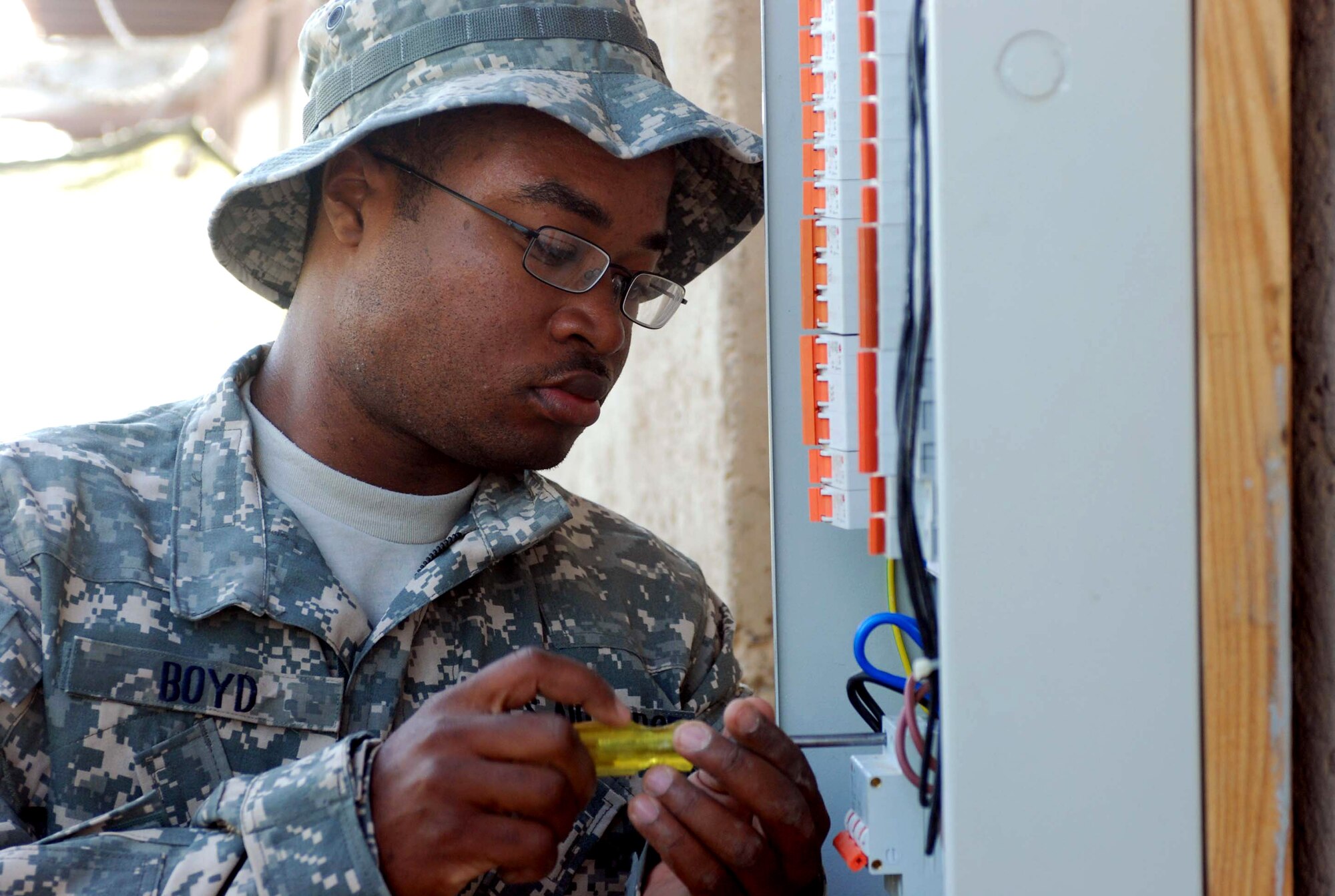 Staff Sgt. Taraus Boyd works on the wiring of the new classroom at the Iraqi police training site at Balad Air Base, Iraq.  Along with building the classroom, Airmen built a mock checkpoint, covered live-fire range and living quarters for the students. Sergeant Boyd, 732nd Expeditionary Logistics Readiness Squadron, Det. 6 electrician, is deployed from Beale Air Force Base, Calif. (U.S. Army photo/Spc. Jay Venturini) 
