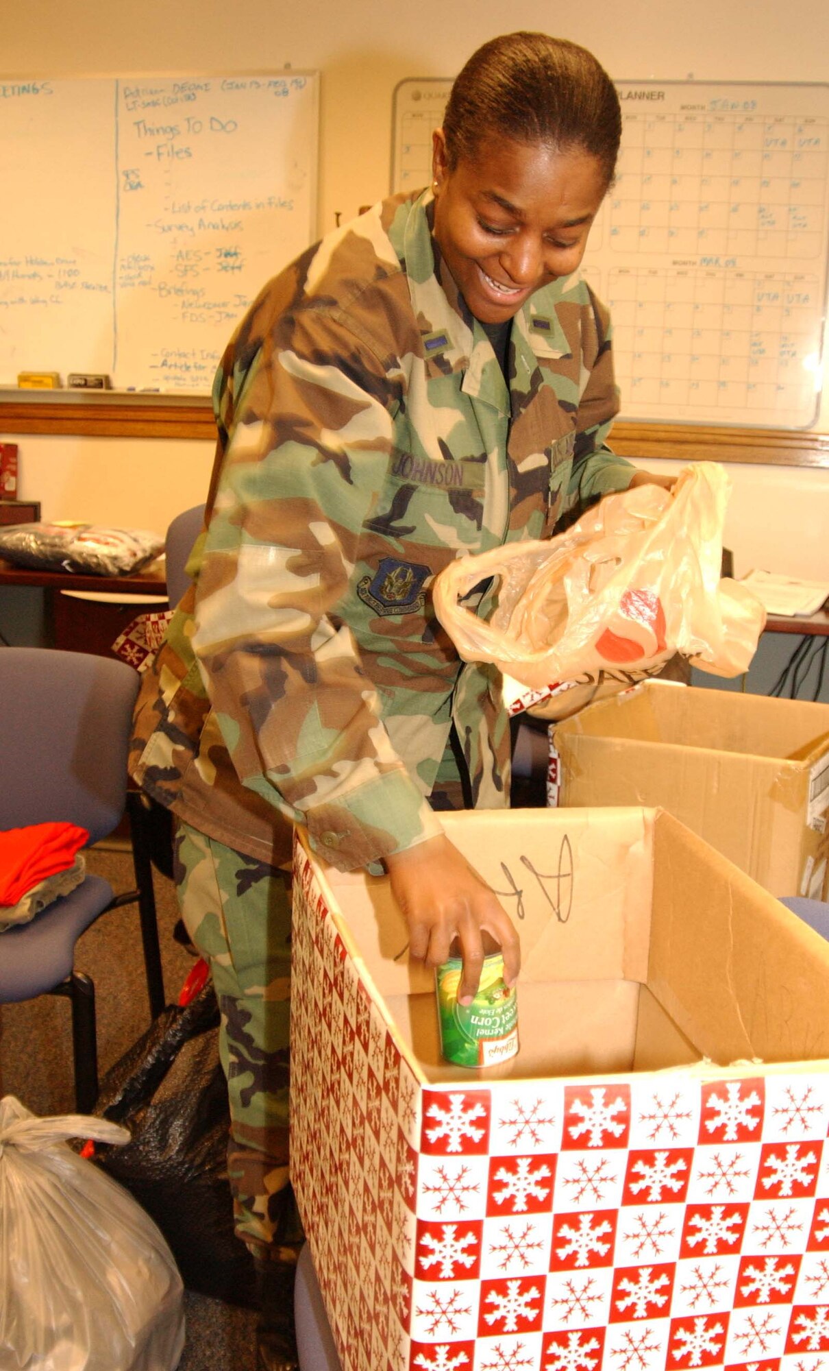 ANDREWS AIR FORCE BASE, Md. -- 1st Lt. Lavonne Johnson, 459th Air Refueling Wing Military Equal Opportunity chief, loads canned goods donated by wing members for the Holiday Food and Gift Drive Dec. 12. Lieutenant Johnson worked with the Human Resources Development Council here to assist a women and children's shelter in Charles County, Md., with money, food and supplies. (U.S. Air Force photo/Staff Sgt. Amaani Lyle)