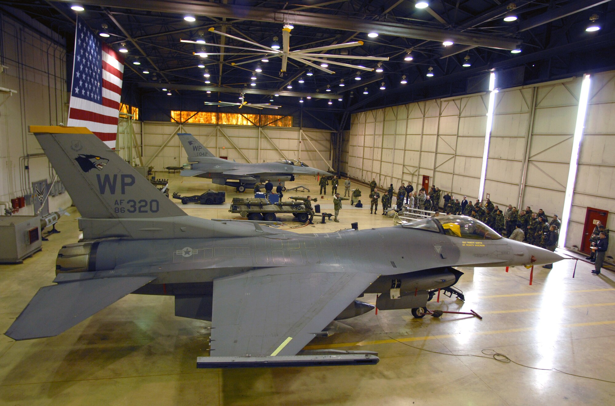 Airmen gather to watch a weapons load competition Dec. 14 at Kunsan Air Base, South Korea. Load crews from the 35th and 80th Fighter squadrons competed in the final load competition for 2007. (U.S. Air Force photo/Senior Airman Steven R. Doty)