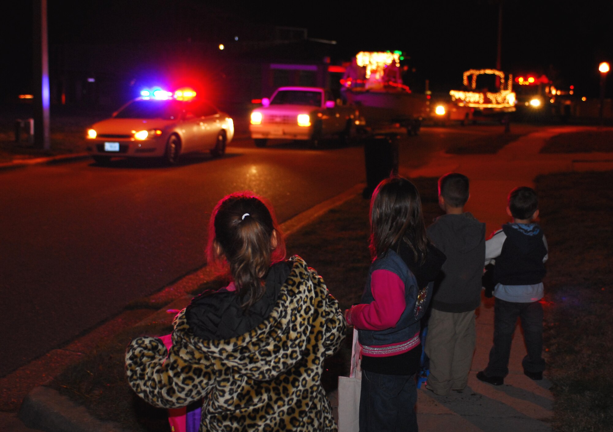 Children wait outside their homes at base housing to watch the first Jingle Jangle Sing-A-Long parade Dec. 18 at Hurlburt Field. Volunteers from services, security forces, the base chapel, and the fire department manned the helm and sang to the crowds as they traveled around base. (U.S. Air Force photo/Airman 1st Class Jason Epley)