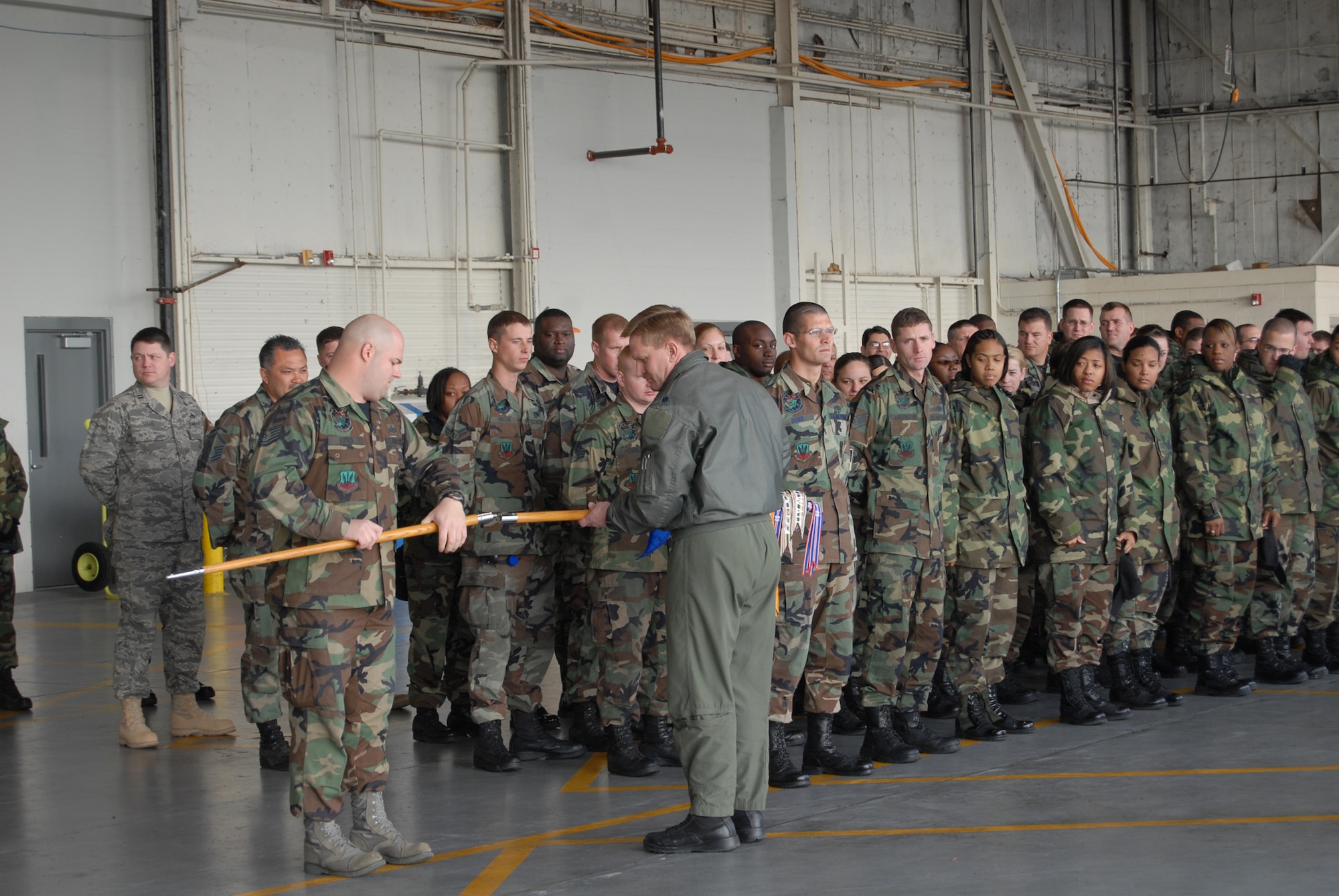 Tech. Sgt. Gary Kimes, 74th Fighter Squadron, and Lt. Col. Russell Myers, 74th FS Commander take about the 23rd Wing flag at a ceremony commending the Flying Tigers. The last three A-10 Thunderbolt II aircrafts left for Moody Air Force Base today. (U.S. Air Force photo/Staff Sgt. Cassandra Locke)