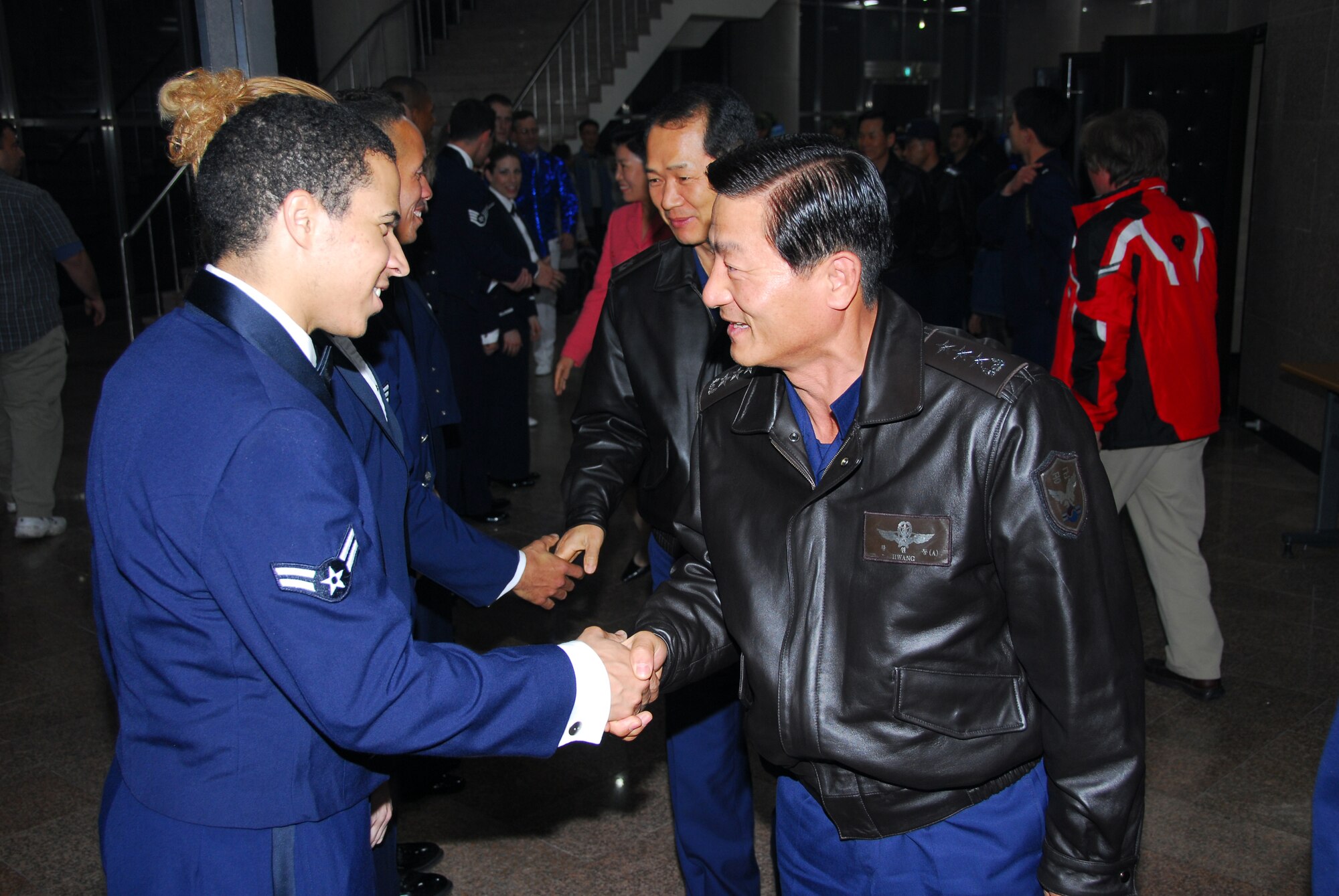 OSAN AIR BASE, Republic of Korea -- U. S. Air Force Tops in Blue vocalist, Airman 1st Class Jesse Cox, receives a "Thank You" from Lt. Gen. Hawing, Wending, ROKAF Academy Commander during Tops in Blue's annual world tour celebrating "The Fly-By", a musical tribute to 60 years of proud Air Force history. (U. S. Air Force photo by Staff Sgt. Ronnie Hill)  