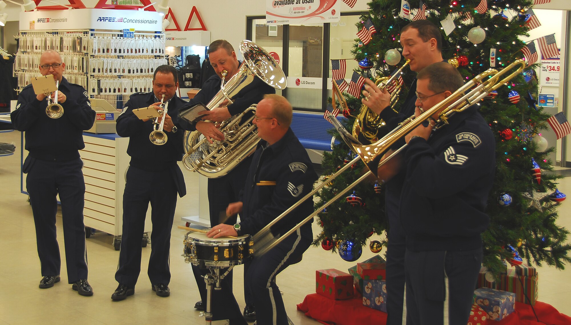 OSAN AIR BASE, Republic of Korea --  Members of the Band of thePacific's Alaska Brass perform Christmas carols at the Osan Base Exchange recently. The band, stationed at Elmendorf Air Force Base, Alaska, performed holiday music around Osan, as well as in the local community. (U.S. Air Force photo by Staff Sgt. Ronnie Hill)