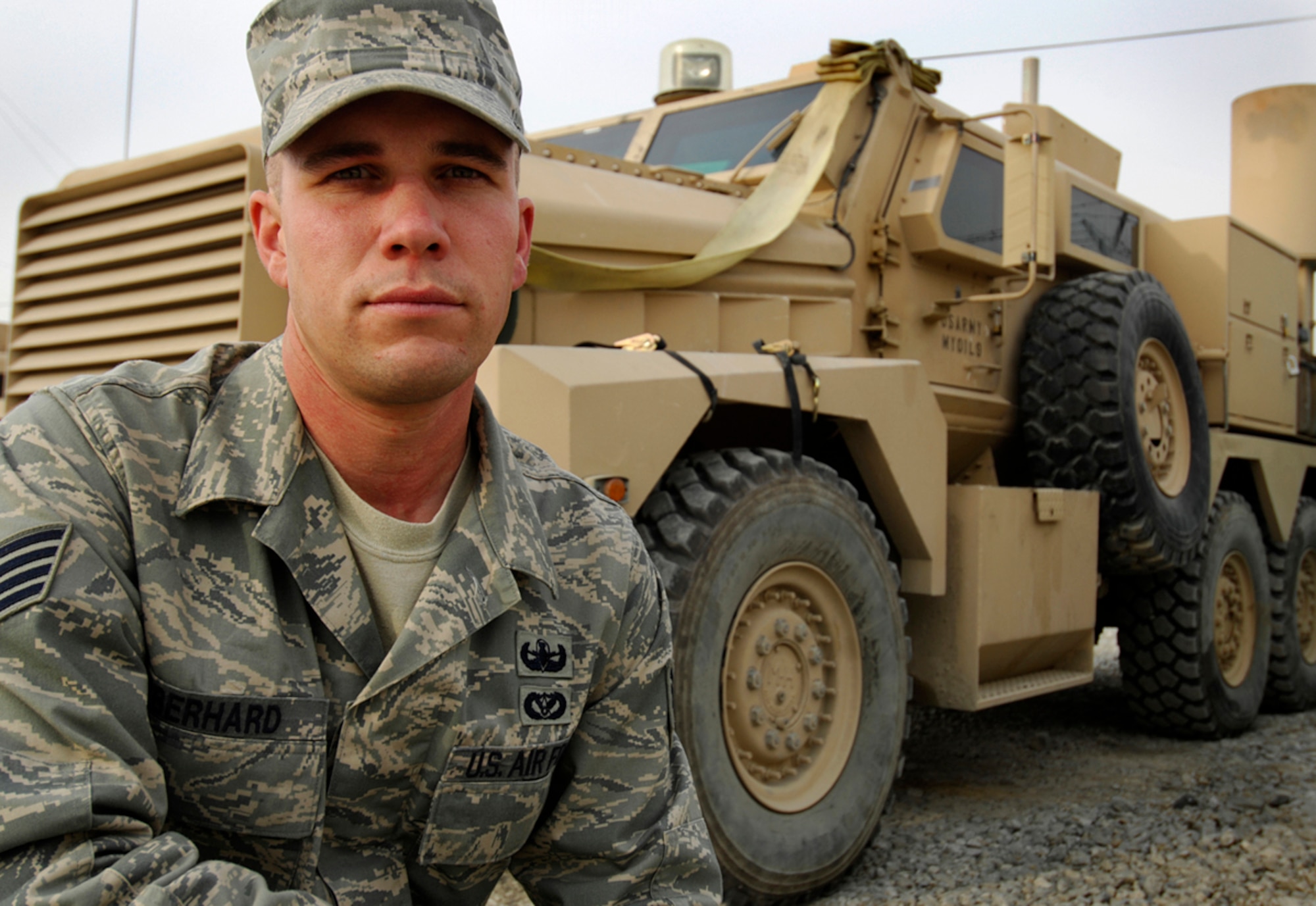 BAGRAM AIR BASE, Afghanistan -- Staff Sgt. Eric Eberhard, a Salt Lake City native deployed from the 419th Civil Engineer Squadron at Hill Air Force Base, Utah, kneels in front of a Joint Explosive Ordnance Disposal Rapid Response Vehicle (JERRV) here Dec. 17, 2007.  Side by side with an Army medic, Sergeant Eberhard's helped save the life of the leader of his three-person EOD team after an improvised explosive device detonated near them Dec. 7. (U.S. Air Force Photo by Staff Sgt. Josh Jasper)