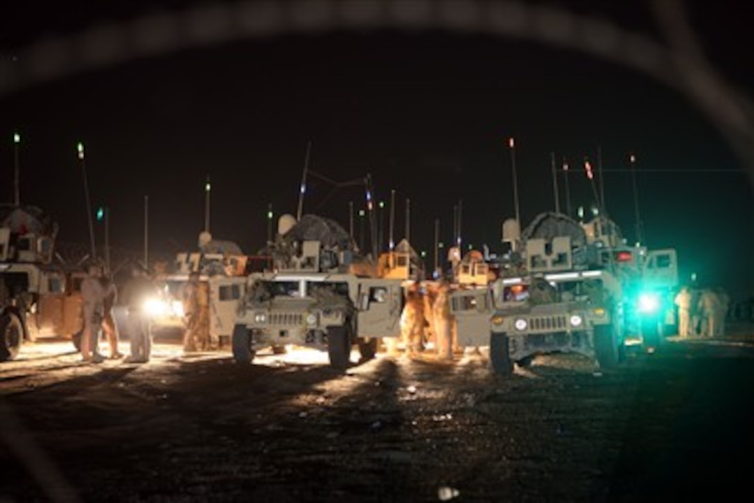 U.S. Marines from 1st and 3rd Battalion, 1st Brigade, 7th Iraqi Army Division, Military Transition Teams prepare their vehicles for a night mission at Camp Taji, Iraq, on Dec. 4, 2007.  