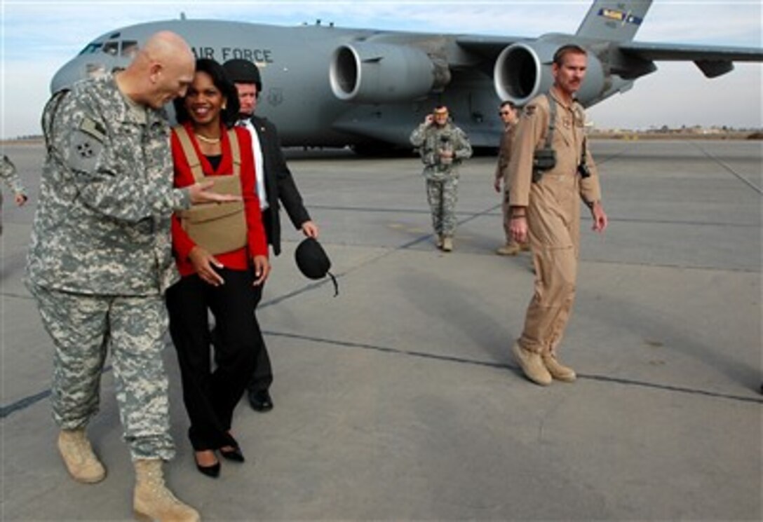 Commander of Multi-National Corps - Iraq Lt. Gen. Ray Odierno, U.S. Army, speaks with Secretary of State Condoleezza Rice as she arrives at Baghdad International Airport, Iraq, on Dec. 18, 2007.  Rice's visit to Iraq includes stops in Baghdad's International Zone and the northern city of Kirkuk.  