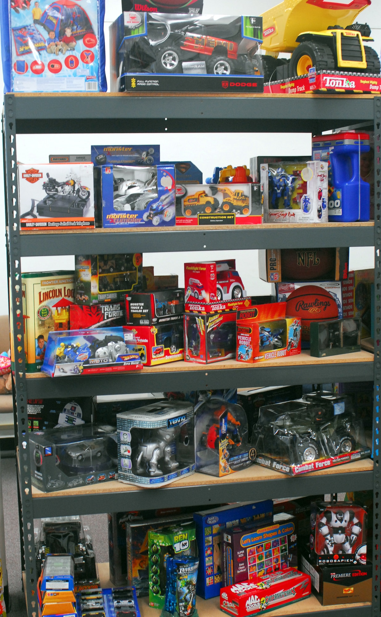 Large toys are displayed on a shelf in the Toy Store in classroom one of the Airman and Family Readiness Center. Toys For The Troops' Kids donated toys to the Airman and Family Readiness Center to be handed out to families of deployed Airmen. Each child will be able to choose 2 toys, one large and one small toy or two small toys. Photo by Staff Sgt. Erin Smith
