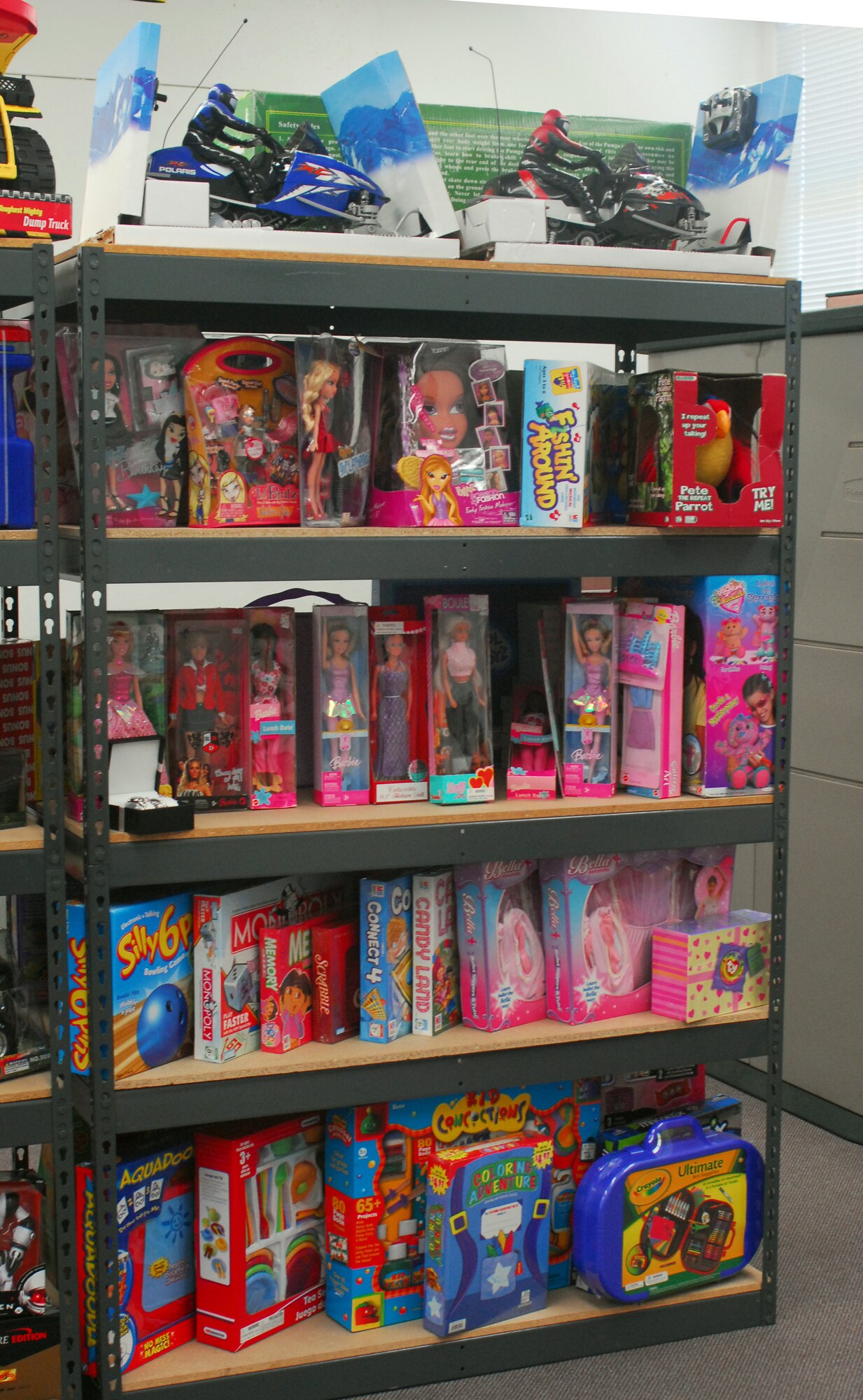 Large toys are displayed on a shelf in the Toy Store in classroom one of the Airman and Family Readiness Center. Toys For The Troops' Kids donated toys to the Airman and Family Readiness Center to be handed out to families of deployed Airmen. Each child will be able to choose 2 toys, one large and one small toy or two small toys. Photo by Staff Sgt. Erin Smith