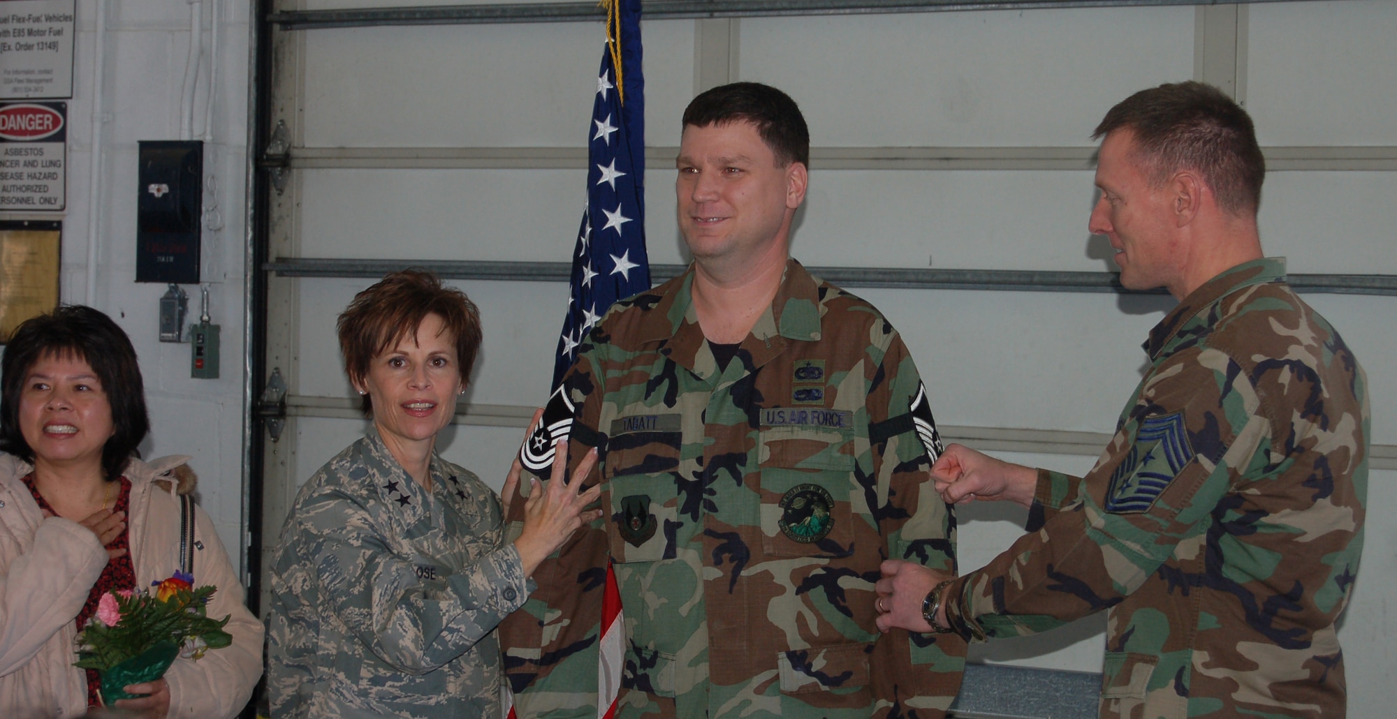 Master Sgt. Mark Tabatt, 75th Logistics Readiness Squadron, shows off his new rank after Maj. Gen. Kathleen Close, Ogden Air Logistics Center commander, promoted him under the Stripes for Exceptional Performers program Dec. 21. Sergeant Tabatt's wife, Chum-man (left), and Chief Master Sgt. William Gurney (right), 75th Air Base Wing and OO-ALC command chief were also present. (U.S. Air Force Photo by Senior Airman Brok McCarthy)