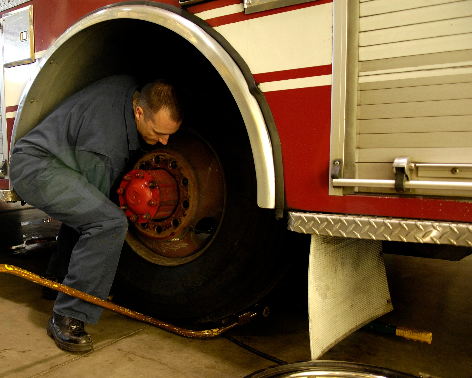 VANDENBERG AIR FORCE BASE, Calif. -- Staff Sgt. Jason Walters, 30th Logistics Readiness Squadron, changes a tire on a fire engine on Dec. 5.  Sergeant Walters recently returned from convoy duty in Iraq while stationed at Camp Arifjan, Kuwait. (U.S. Air Force photo/Airman 1st Class Jonathan Olds)
