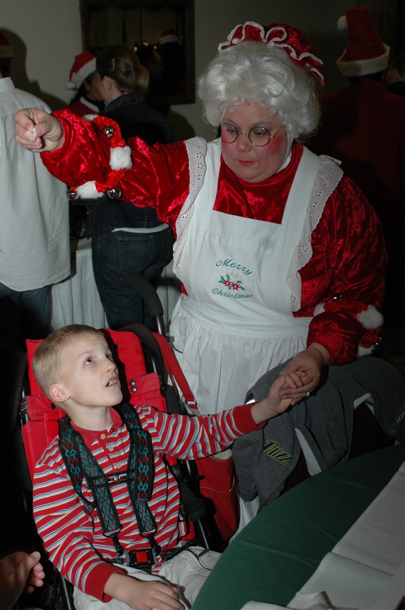 Mrs. Claus and Matthew Chastain play holiday games during the Holiday Blast Special Needs Dinner at the Travis Conference Center Dec. 12. The event featured games, prizes and caroling. (U.S. Air Force photo/Staff Sgt. Matthew McGovern)
