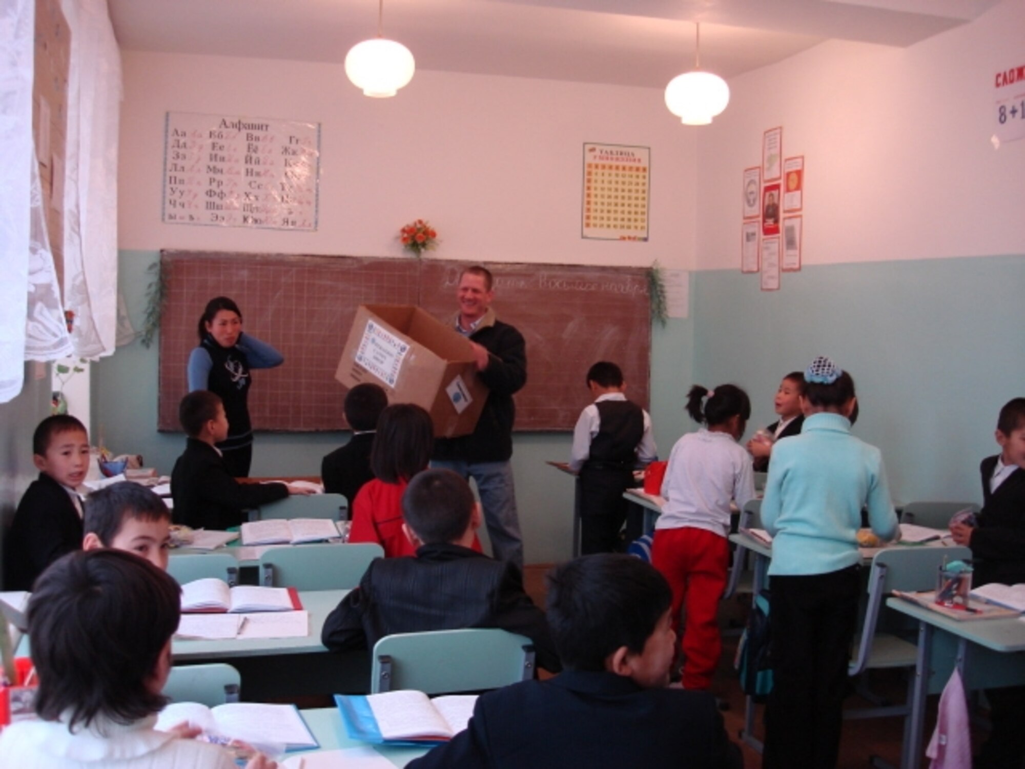 Capt. Fred Testa, 376th Expeditionary Security Forces Squadron, hands out candy at the Nizhanchuisk Orphanage, Gargarin, Kyrgyzstan. The candy was collected at Travis as part of Operation Candy Drop. (U.S. Air Force photo)