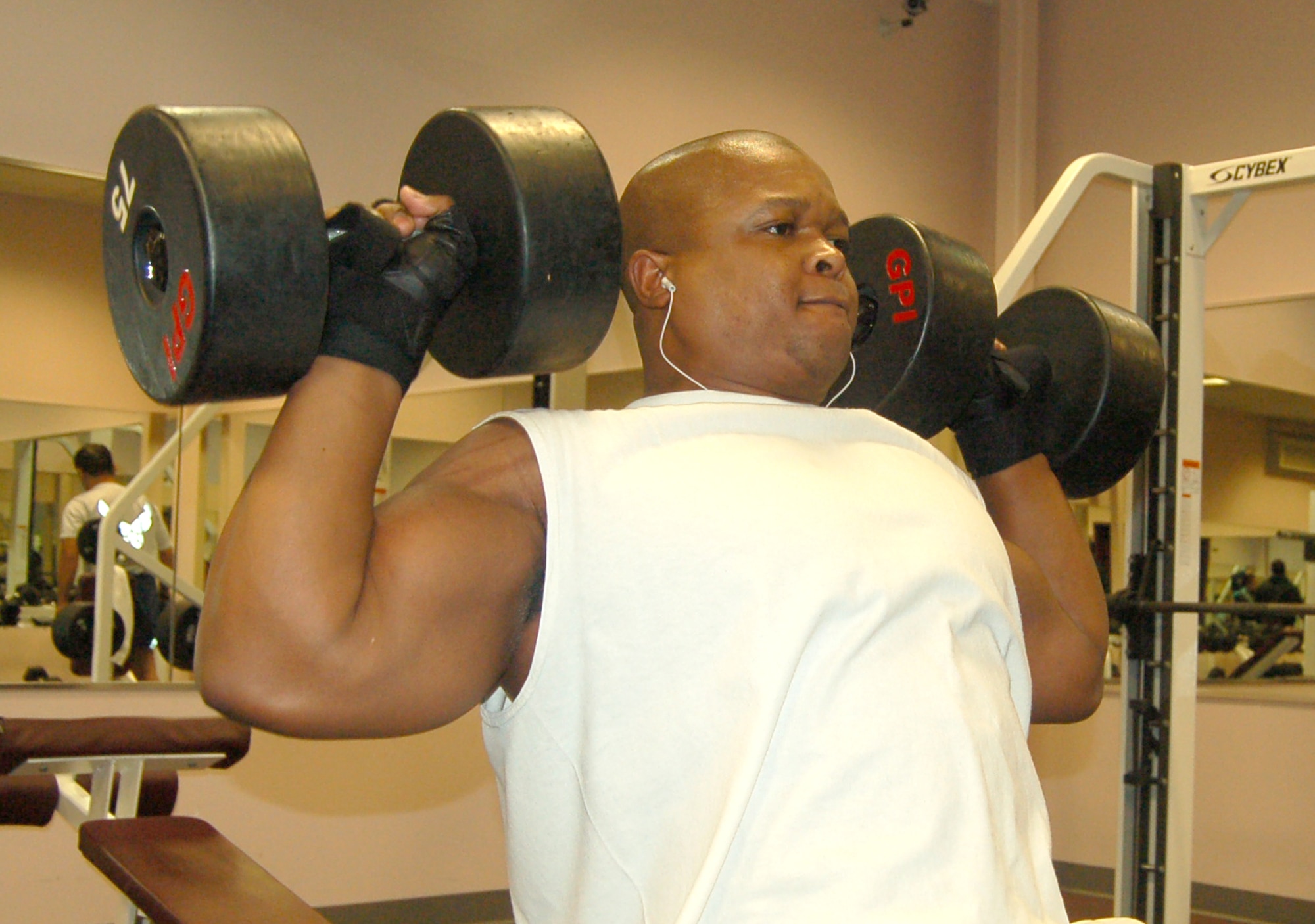 Mr. Cyrus Ford lifts weights in the base fitness center Dec. 13. Mr. Ford, a member of the 21st Space Communications Squadron, is ranked number one in his weight class for lifitng in Colorado by the National Athelete Strength Association and holds American records in bench press, curl and dead lift. (U.S. Air Force photo/Corey Dahl)