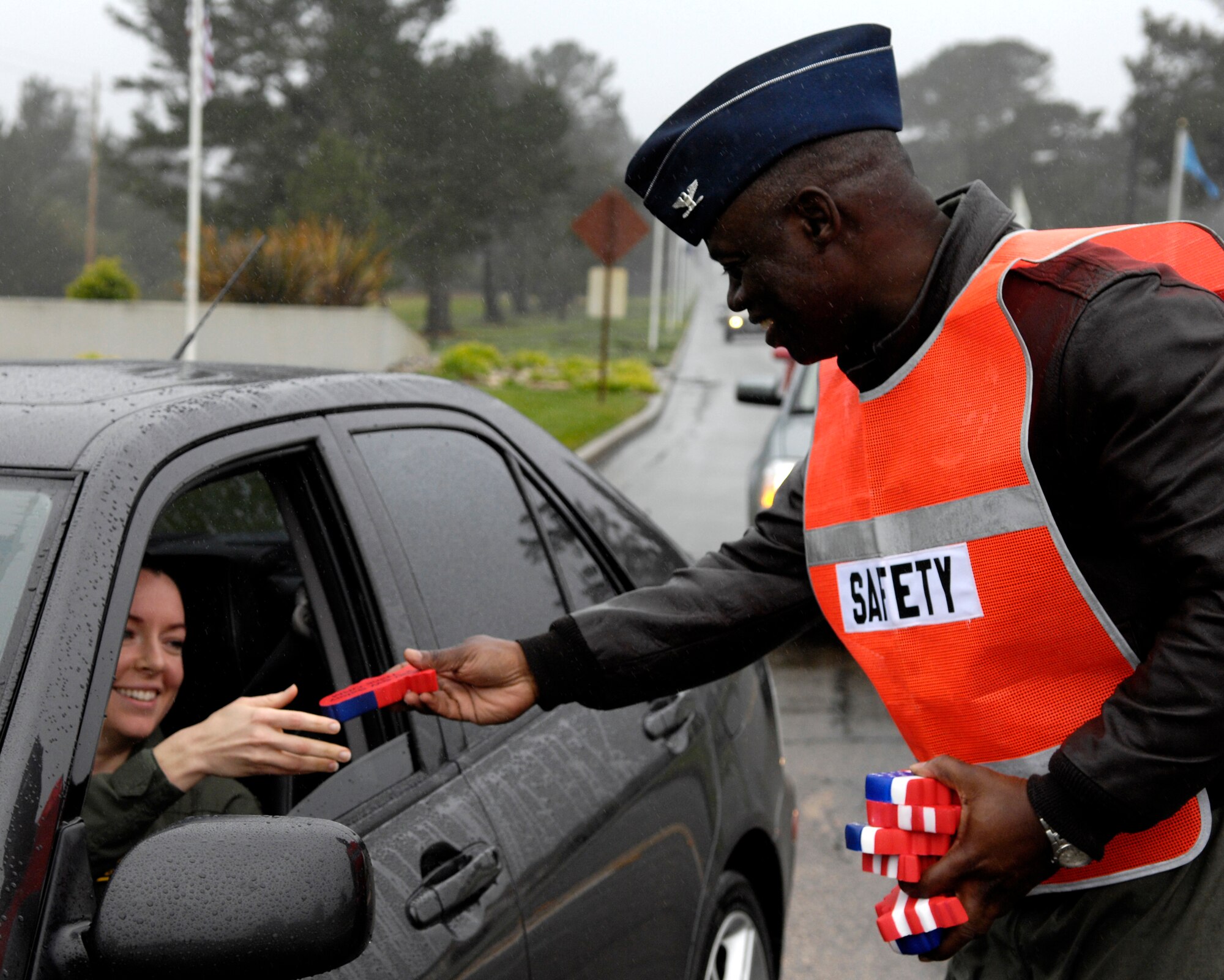 VANDENBERG AIR FORCE BASE, Calif. -- Col. Andre Lovett, 30th Operations Group commander, conducts seat belt checks and gives holiday greetings at the Santa Maria Gate on Dec. 20.  Col Lovett, along with Col. Steve Tanous, 30th Space Wing commander, and Tech. Sgt. Thomas Weaver, 30th Space Wing Safety, inspected Vandenberg motorists to promote safety over the holidays. (U.S. Air Force photo/Airman 1st Class Jonathan Olds)
