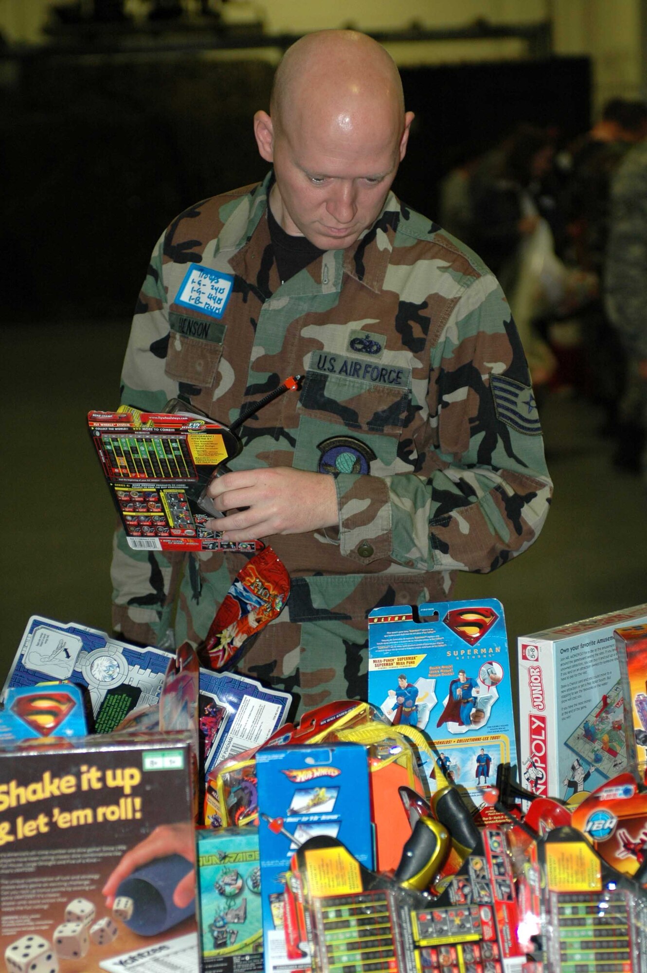 Tech. Sgt. Michael Henson, 573rd Global Support Squadron, looks through toys at the Toys for Troops event in Hangar P-1 Dec. 20. (U.S. Air Force photo/Airman 1st Class Kristen Rohrer)
