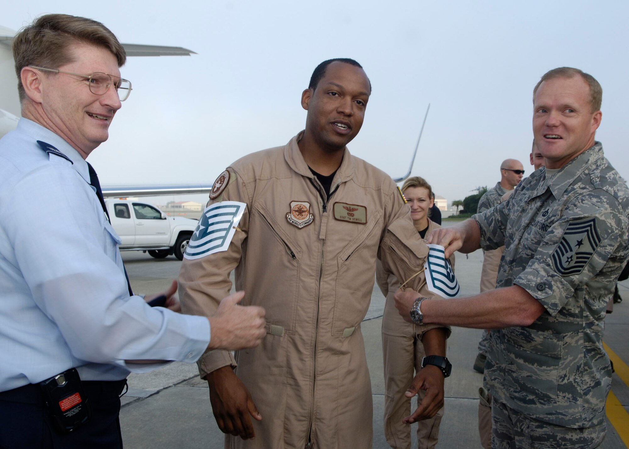 Tech. Sgt. Tim Sewell, 310th Airlift Squadron, shows his surprise as he is promoted on-the-spot to technical sergeant through the Stripes for Exceptional Performers program by Col. Robert Thomas, 6th Air Mobility Wing commander and Chief Master Sgt. James Cody, 6th Air Mobility Wing command chief. (Photo by Airman 1st Class Stephenie Wade)