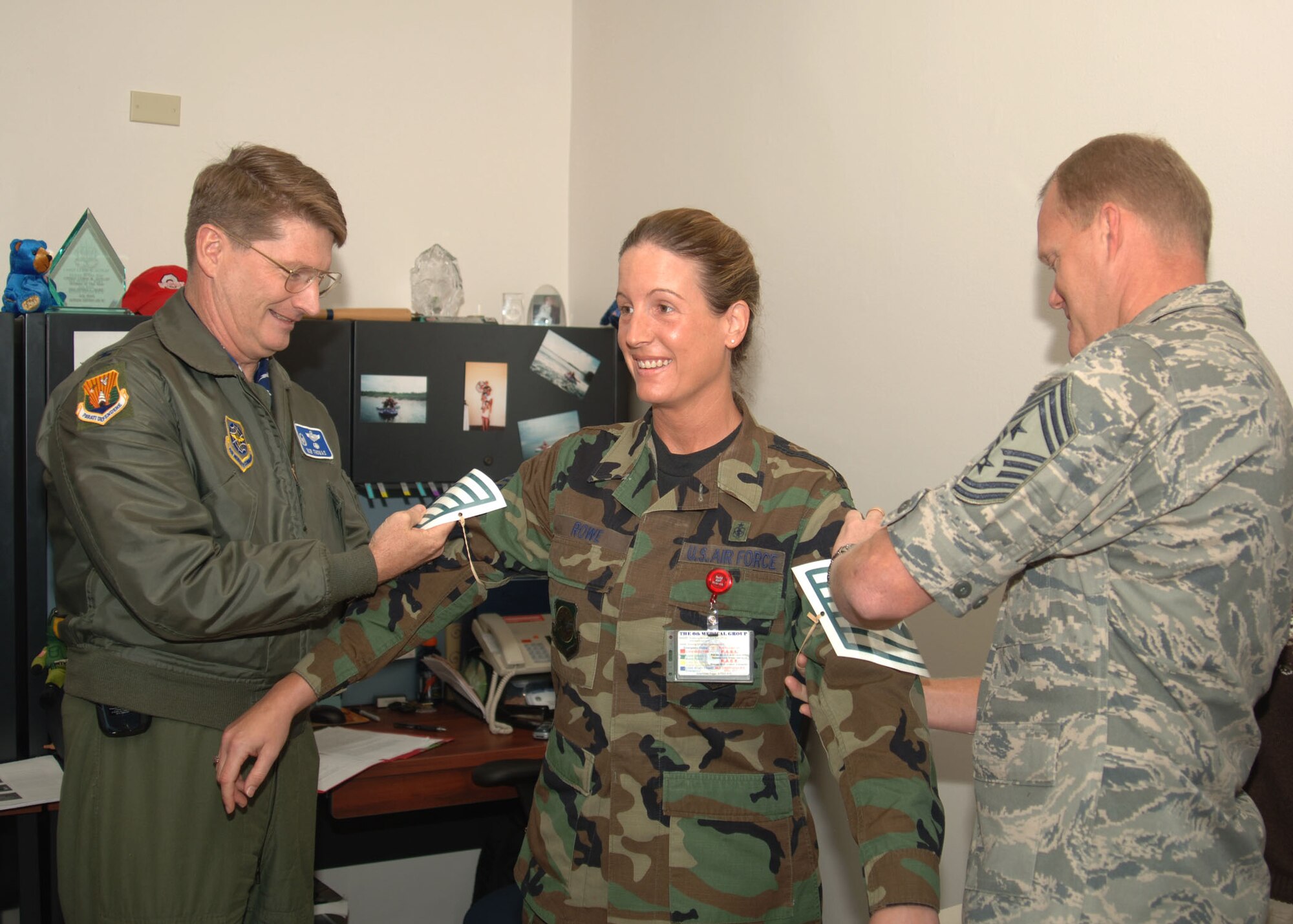 Tech. Sgt. Duska Rowe, 6th Medical Operations Squadron, shows her surprise as she is promoted on-the-spot to technical sergeant through the Stripes for Exceptional Performers program by Col. Robert Thomas, 6th Air Mobility Wing commander and Chief Master Sgt. James Cody, 6th Air Mobility Wing command chief. (Photo by Senior Airman Patrice Clarke)