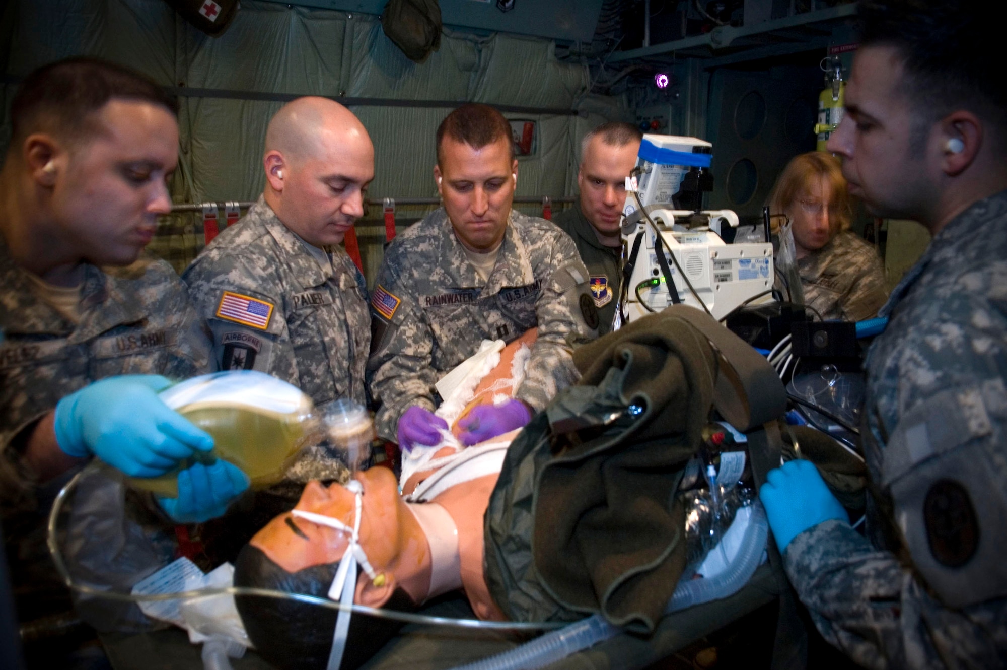 Special medical augmentation response team members based at Brooke Army Medical Center at Fort Sam Houston, Texas, care for a simulated burn patient inside a C-130 Hercules aircraft simulator at Brooks City-Base, Texas. It's part of critical care air transport team training conducted by the School of Aerospace Medicine at Brooks City-Base. (U.S. Air Force photo/Steve Thurow)