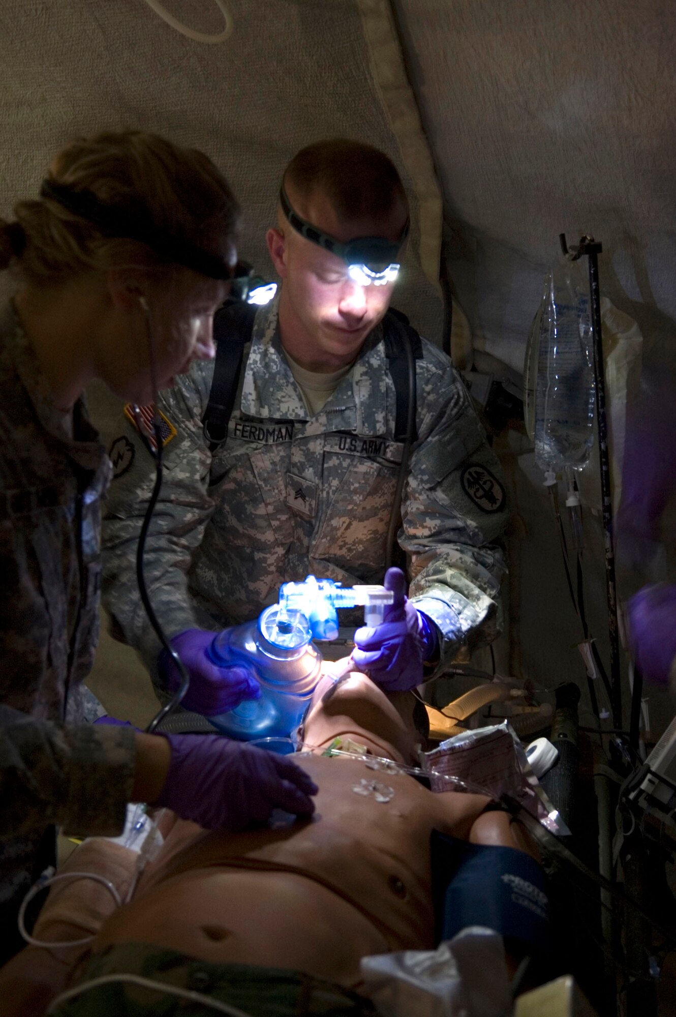 Army Sgt. Ryan Ferdman helps a simulated patient breathe during critical care air transport team training conducted by the Air Force School of Aerospace Medicine at Brooks City-Base, Texas. The course prepares CCATT members for medical evacuation operations and duties. Sergeant Ferdman is a respiratory therapist with the Pacific Air Forces CCATT at Tripler Army Medical Center in Hawaii. (U.S. Air Force photo/Steve Thurow) 