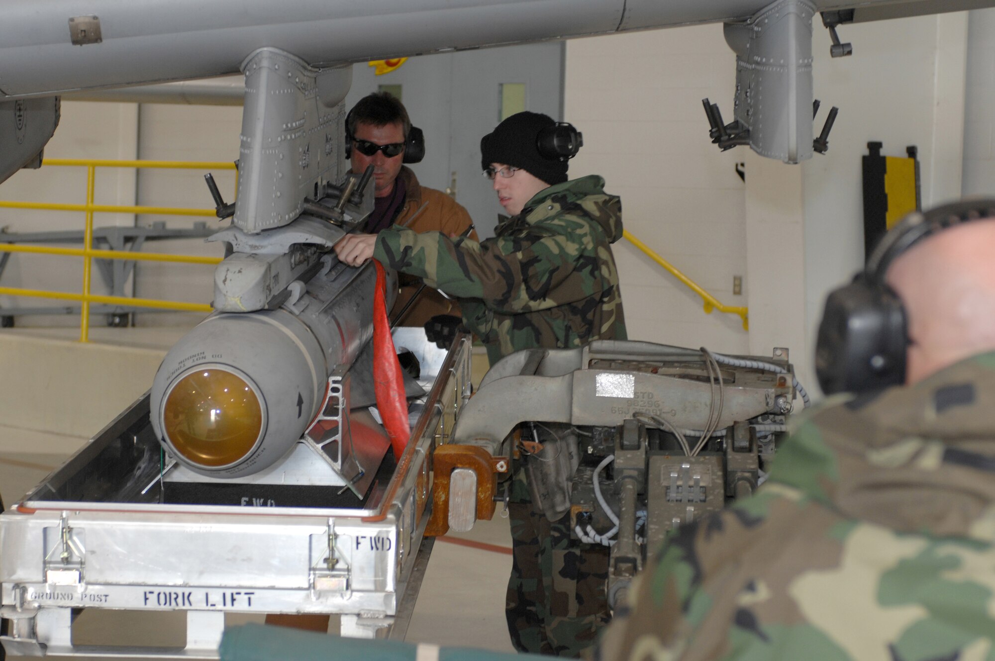 Airman 1st Class Shane Dunn (right) and Master Sgt. Jim Kirksey, 442nd Aircraft Maintenance Squadron, pull the pin to release an AGM-65 Maverick missile onto a Jammer controlled by Tech. Sgt. Ken Portell Dec. 19 at Whiteman Air Force Base, Mo.  The Air Force reservists are members of the 442nd Fighter Wing, which operates, maintains and supports a squadron of A-10 ground attack aircraft. (U.S. Air Force photo/Tech. Sgt. Samuel A. Park) 
