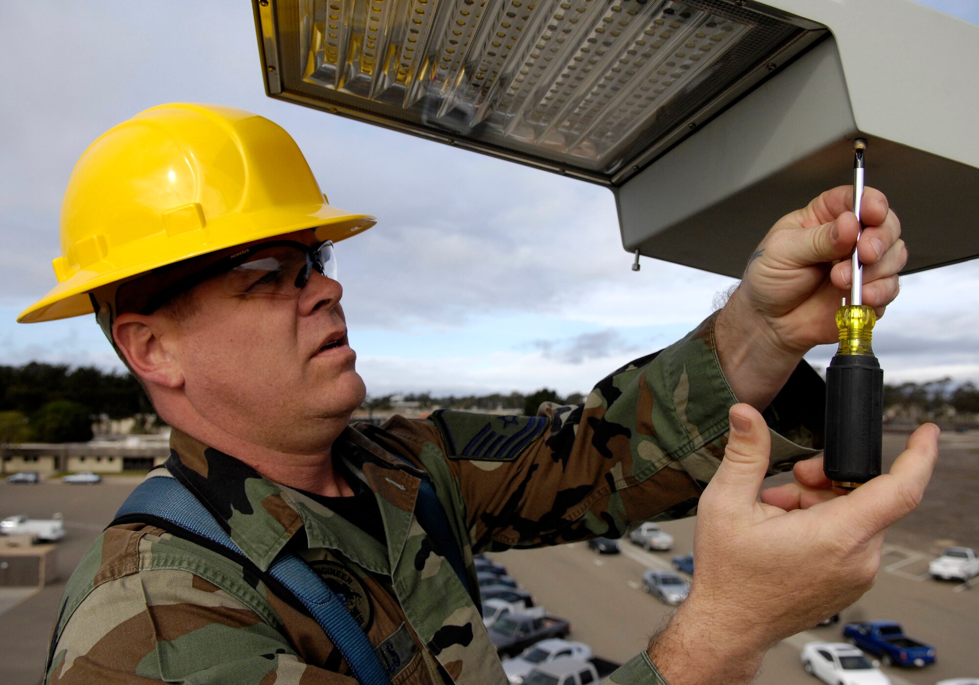 VANDENBERG AIR FORCE BASE, Calif. -- Master Sgt. Russell Wells, 30th Civil Engineering Squadron, inspects a Light Emitting Diode in front of the CES Operations Flight Building on Dec. 17. LED lights are being tested on Vandenberg to possibly replace current sodium vapor lamps. LED lights use three times less energy than sodium vapor lamps. (U.S. Air Force photo/Airman 1st Class Jonathan Olds)