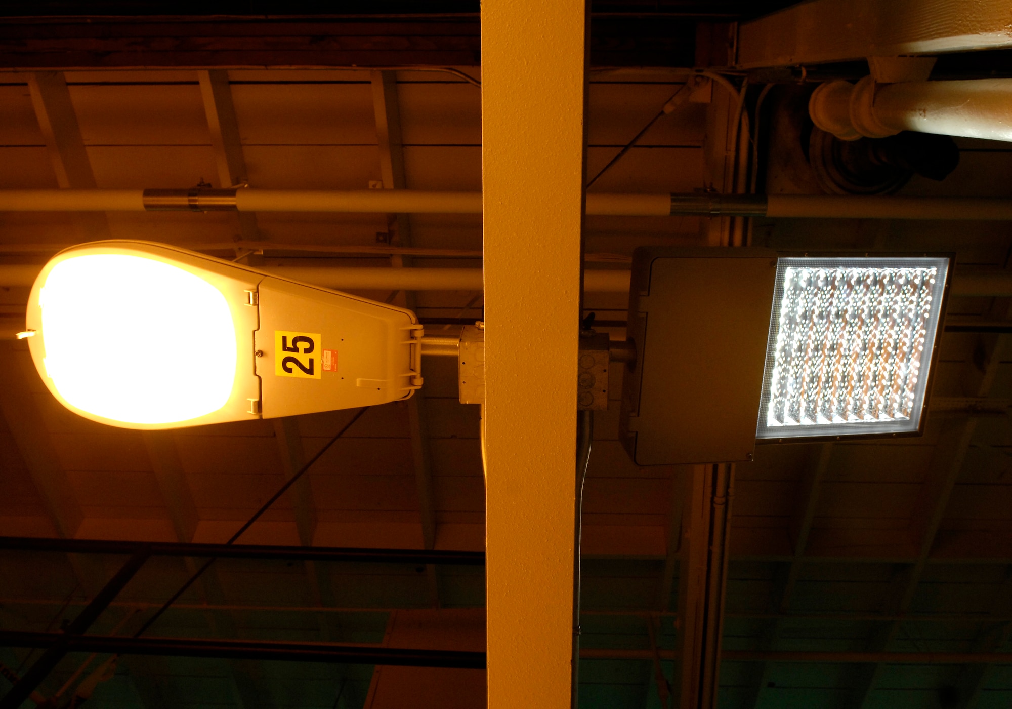 VANDENBERG AIR FORCE BASE, Calif. --  A Sodium Vapor Lamp (left) is lit next to a Light Emitting Diode light in the Civil Engineering Squadron's Operations Flight Building on Dec. 17. LED lights are being tested on Vandenberg to possibly replace current sodium vapor lamps. LED lights use three times less energy than sodium vapor lamps. (U.S. Air Force photo/Airman 1st Class Jonathan Olds)