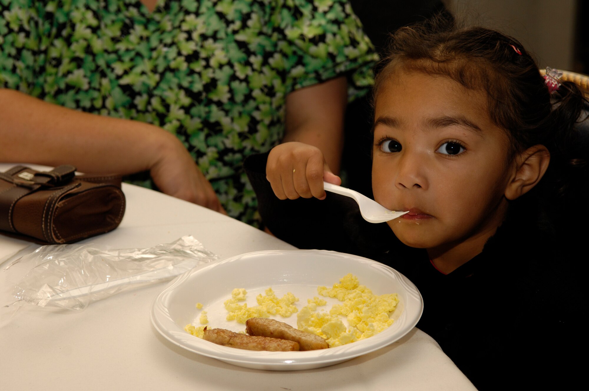 VANDENBERG AIR FORCE BASE, Calif. -- Deziray Warner-Joyner, 3, enjoys a warm morning meal during Breakfast with Santa at the Pacific Coast Club on Dec. 15. Over 500 children attended the annual event hosted by the 30th Services Division. The event was free to the entire base and included a photo opportunity with Santa, breakfast, holiday arts and crafts, games, and prize give-a-ways.  (U.S. Air Force photo/Airman 1st Class Christian Thomas)
