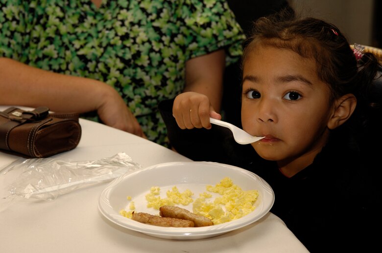 VANDENBERG AIR FORCE BASE, Calif. -- Deziray Warner-Joyner, 3, enjoys a warm morning meal during Breakfast with Santa at the Pacific Coast Club on Dec. 15. Over 500 children attended the annual event hosted by the 30th Services Division. The event was free to the entire base and included a photo opportunity with Santa, breakfast, holiday arts and crafts, games, and prize give-a-ways.  (U.S. Air Force photo/Airman 1st Class Christian Thomas)
