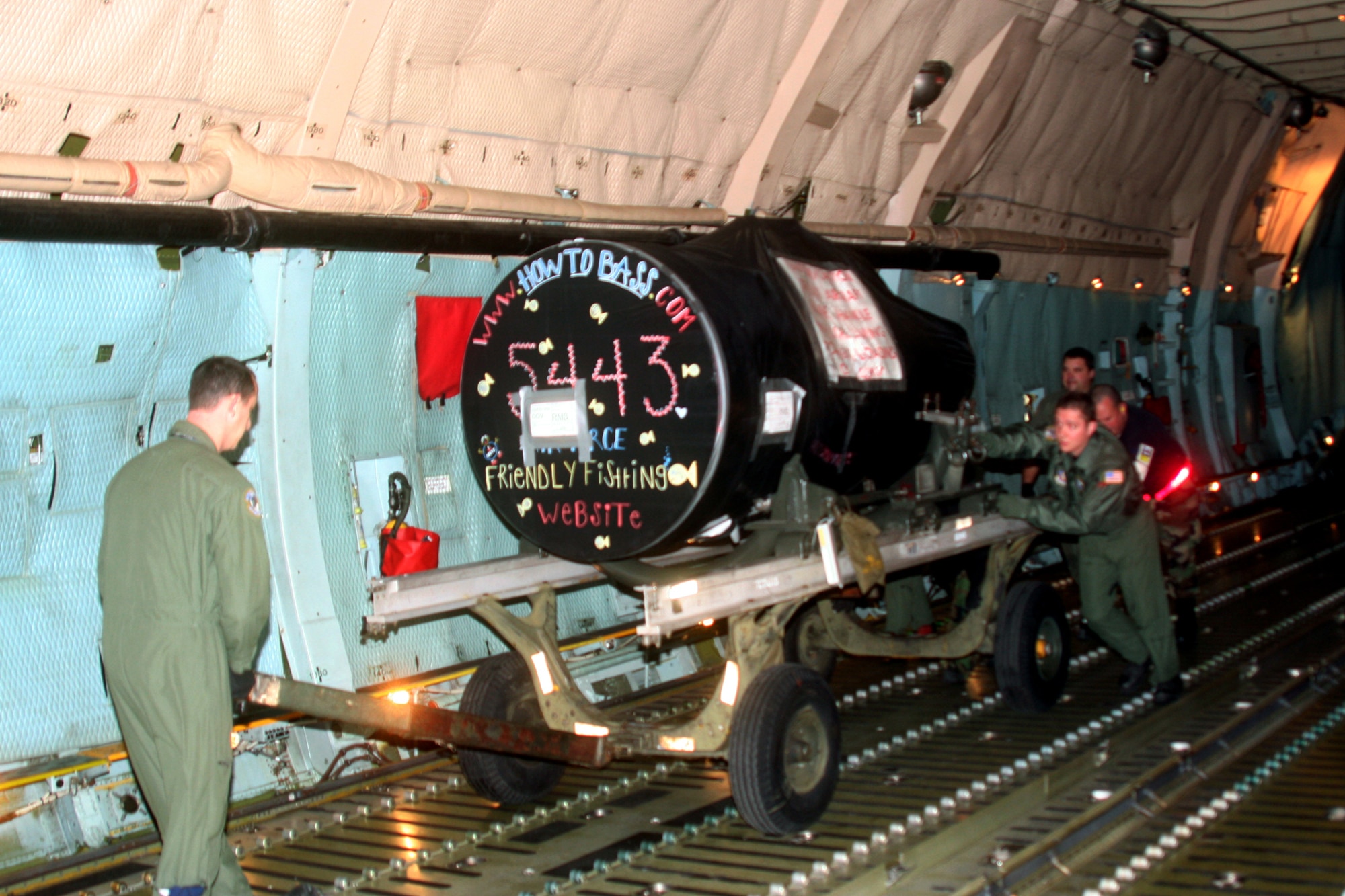 DOVER AIR FORCE BASE, Del --   Loadmasters and base aerial porters load one of two jet engines onto a C-5 aircraft bound for Ramstein Air Base, Germany. (U.S. Air Force photo/Maj. Ted Theopolos)
