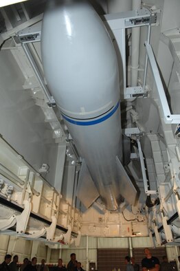 WHITEMAN AIR FORCE BASE, Mo. - Weapon specialists look on as a mock up of the Massive Ordnance Penetrator sits in bomb bay of the B-2 weapons load trainer dec. 18. (Photo printed with permission of Col. Bob Dulong)