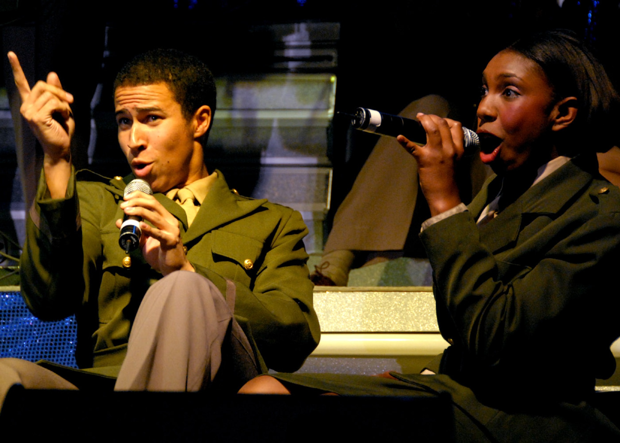 Airman 1st Class Jesse Cox (left) and Senior Airman Chonte Walker perform during their annual world tour celebrating "The Fly-By", a musical tribute to 60 years of proud Air Force history Dec. 19 at Osan Air Base, South Korea. Airmen Cox and Walker are Tops In Blue vocalists. During each annual tour, Tops In Blue entertains more than 250,000 military members and their families, presenting an average of 120 performances at 100 locations worldwide. (U.S. Air Force photo/Senior Master Sgt. Marvin Krause) 
