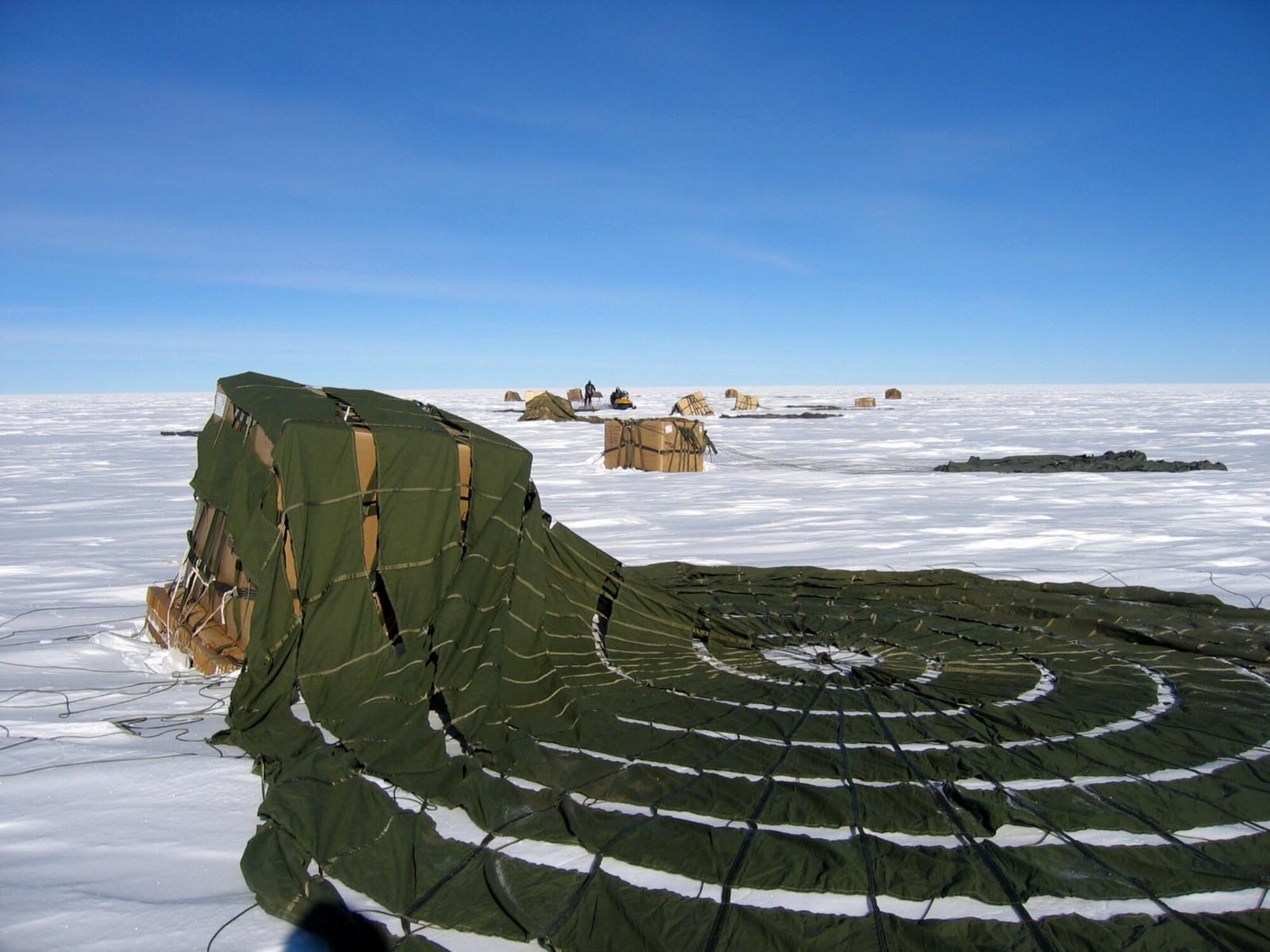 Supplies airdropped by a McChord Air Force Base, Wash., C-17 Globemaster III land at a drop zone at the South Pole Dec. 18. By validating the C-17 capability to complete airdrop missions at the Geographical South Pole, Joint Task Force-Support Forces Antarctica demonstrated its ability to provide mid-winter emergency re-supply and flexible support to the National Science Foundation and U.S. Antarctica Program. (U.S. Air Force photo) 